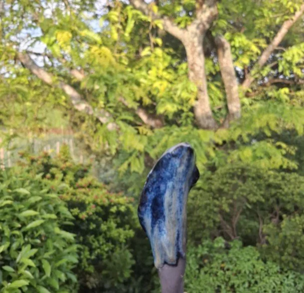 Calla Lily in black clay with deep blue back.jpg