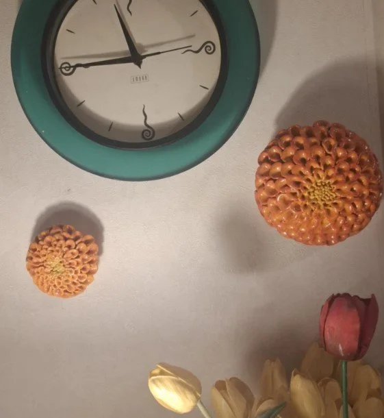 Orange dahlias on wall.jpg