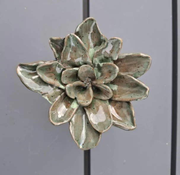 Speckled green medium flower on stake top.jpg