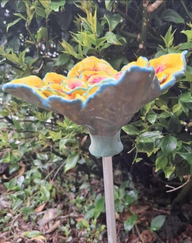 Red and yellow flower with green edge on stake side.jpg