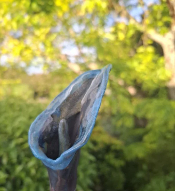 Calla Lily in black clay with light blue side.jpg