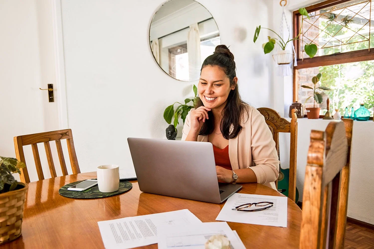 Latina woman smiling during an individual online therapy session from home, receiving culturally responsive mental health support for anxiety, depression, and self-worth in California.