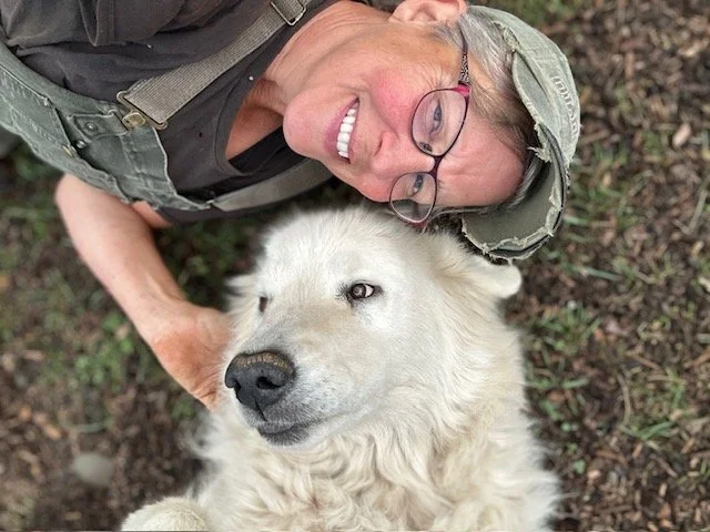 Leia Ray with Milly, her beloved livestock guardian dog, sharing a quiet moment of love and connection on their Washington farm.