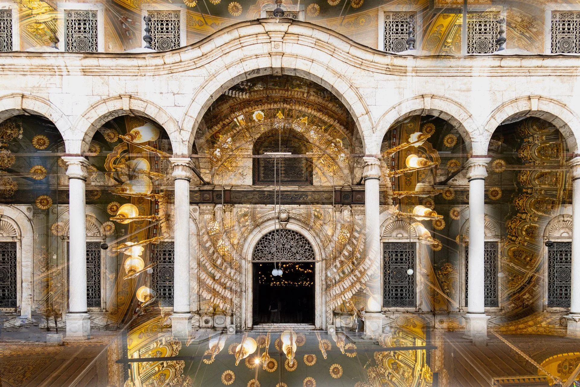 Reflected image of a grand, ornate building with arched windows, columns, decorative facade, and intricate gold details, viewed through a shiny, mirror-like surface.