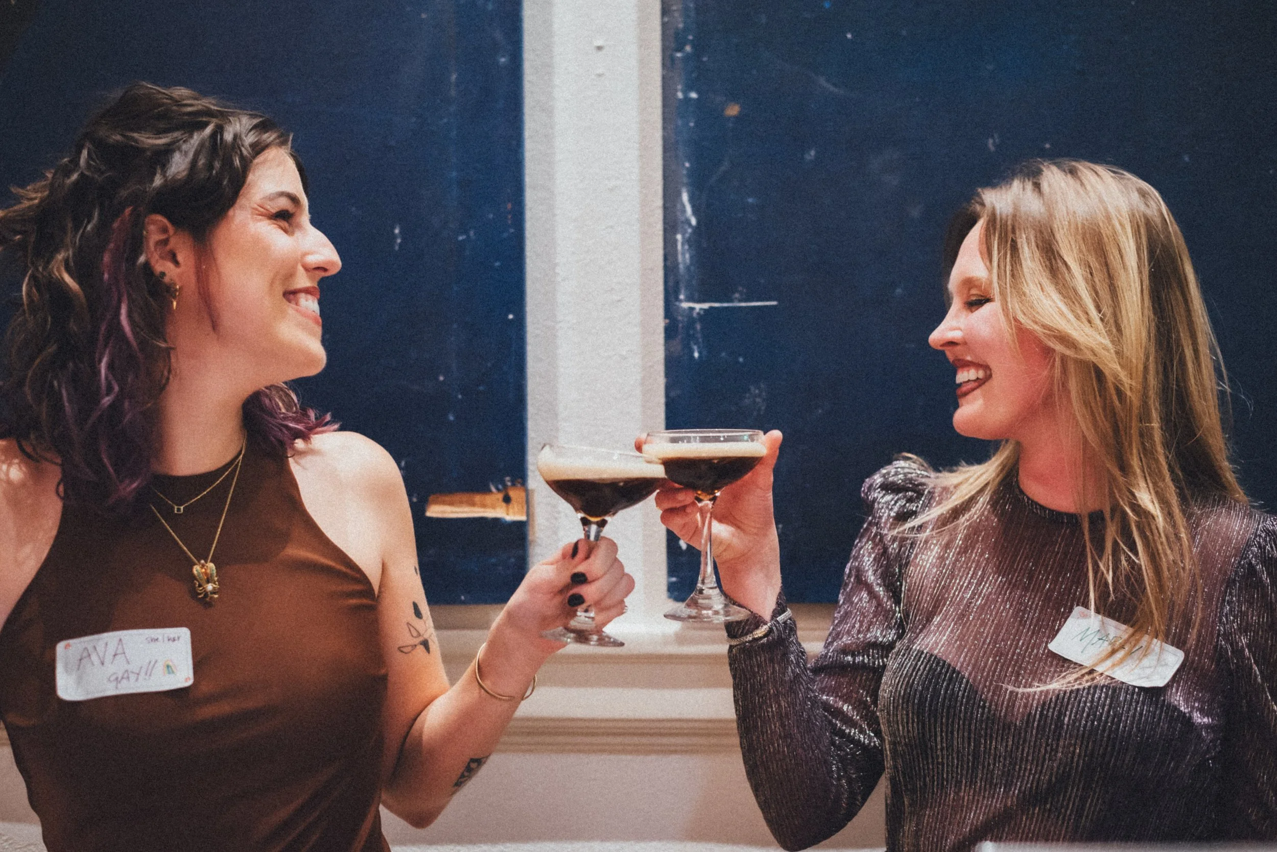 Two women clink the glasses of their espresso martinis at Denver Dance Hall.