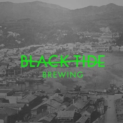 Black and white photo of a city with hills in the background, overlaid with green text that reads "Black Tide Brewing."