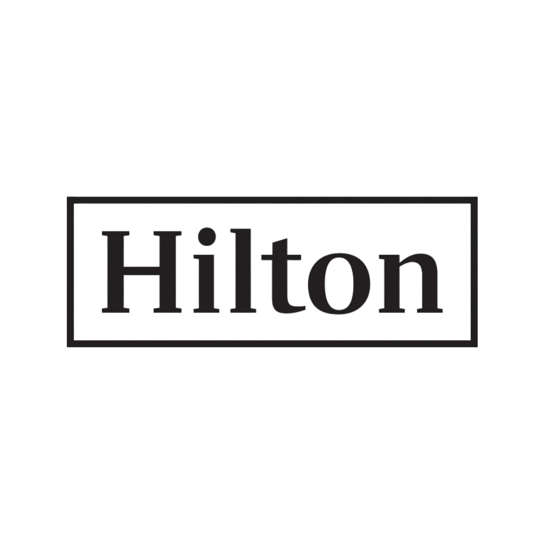 Neon sign displaying the Hilton logo in purple and pink colors.