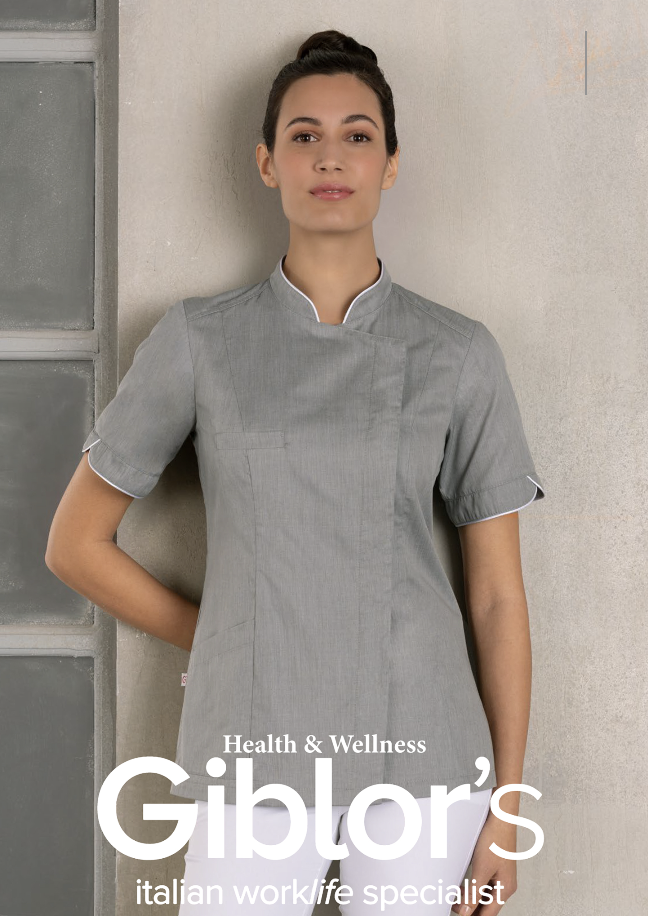 Woman wearing a gray uniform, standing against a concrete wall, holding a white folder, with the text "Health & Wellness Giblór's Italian work/life specialist" on the image.