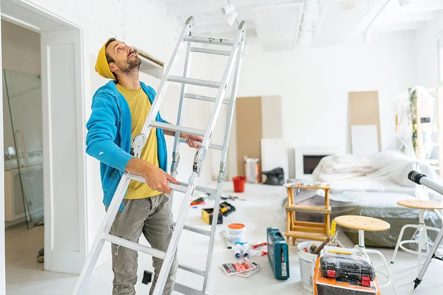 man-with-ladder-working-on-home-renovations.jpg