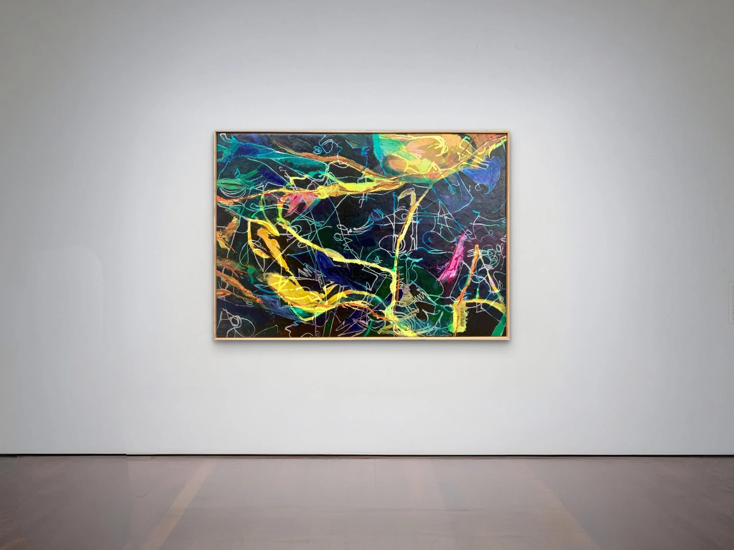 Colorful abstract expressionist painting with bright neon hues on a dark background displayed in a minimalist gallery.