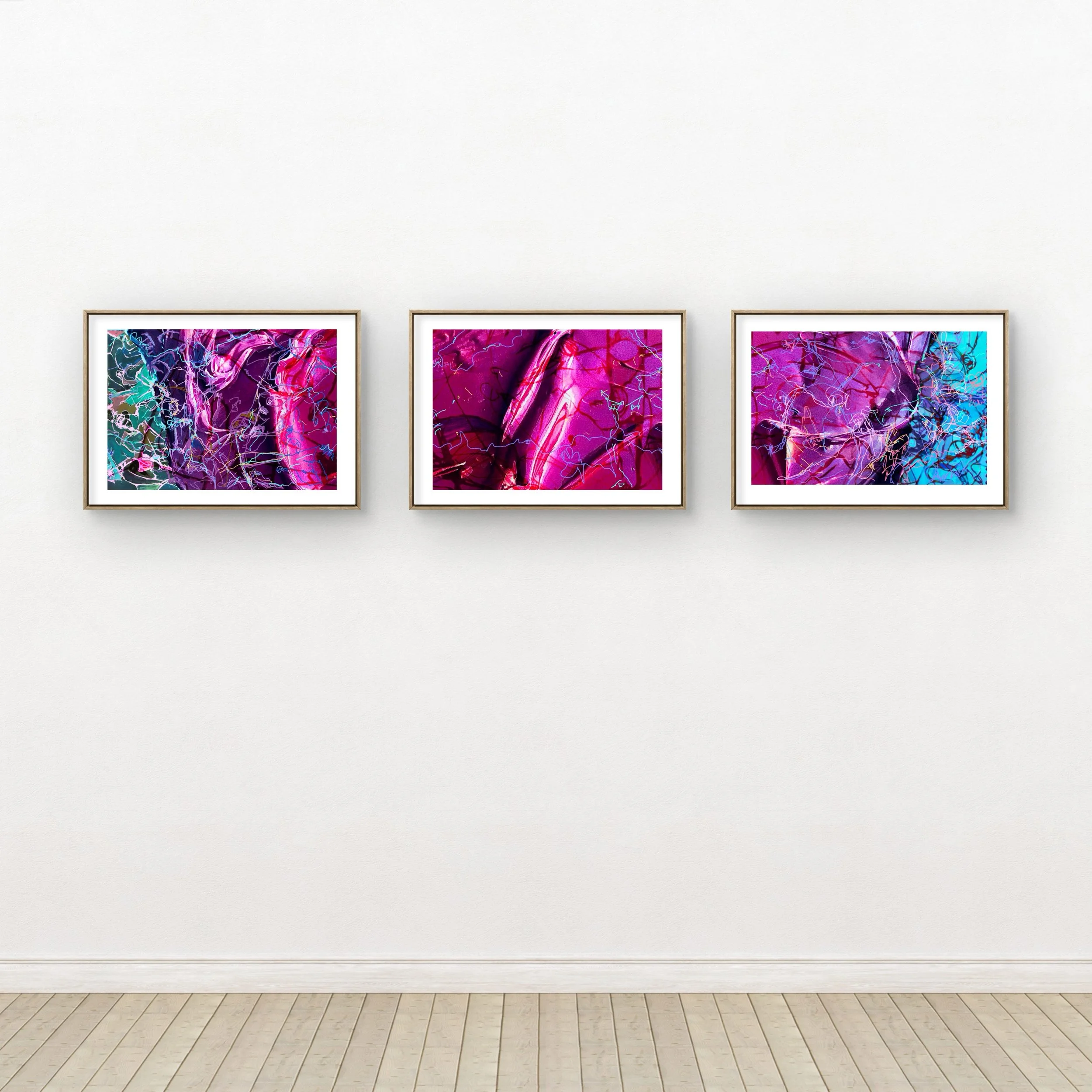 Three framed abstract colorful digital artworks on a gallery white wall.