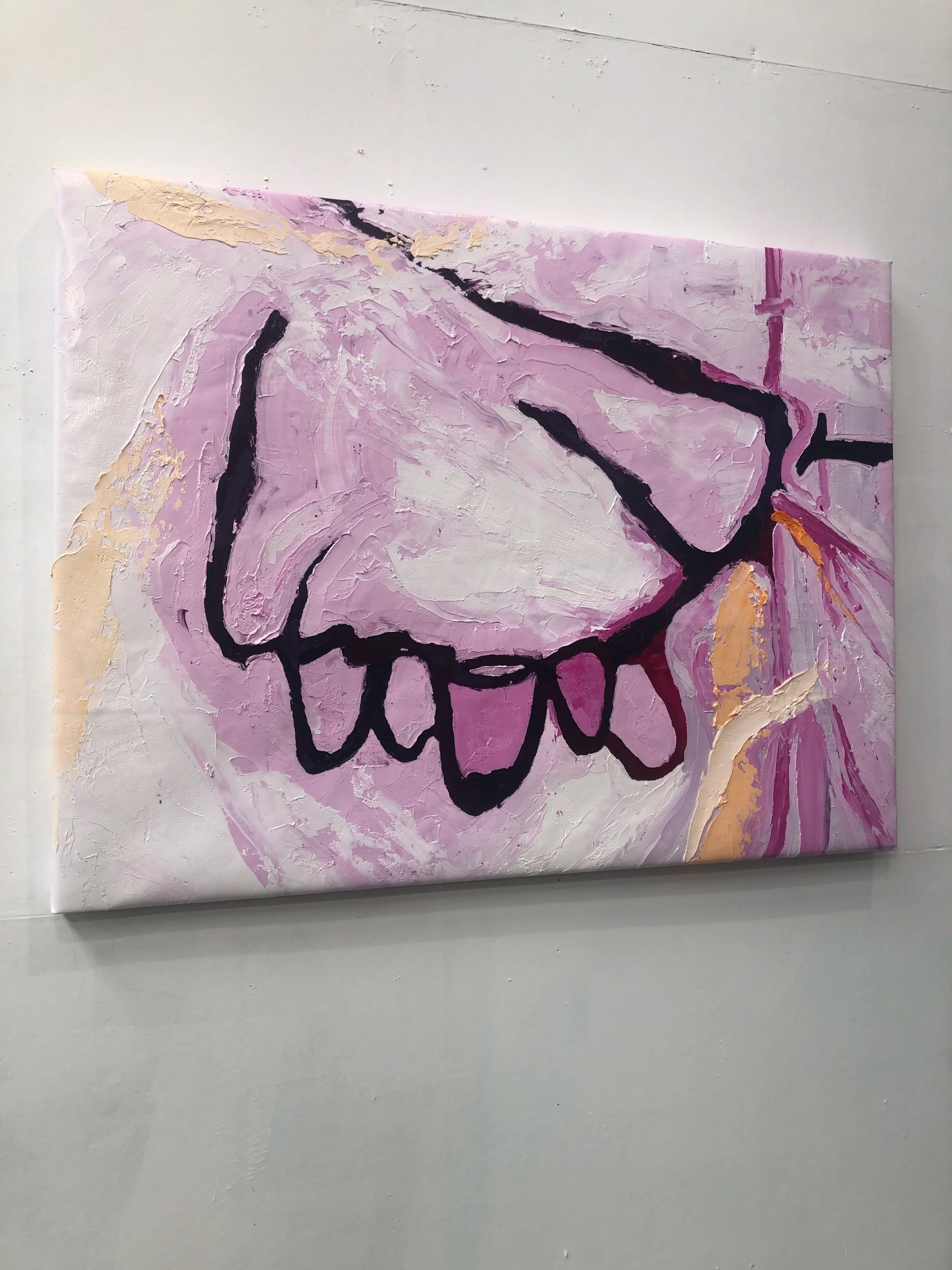 Abstract painting featuring a stylized, gesture-like face with closed eyes, lips, and a nose in bold black outline against a textured pink and purple background with gold accents.