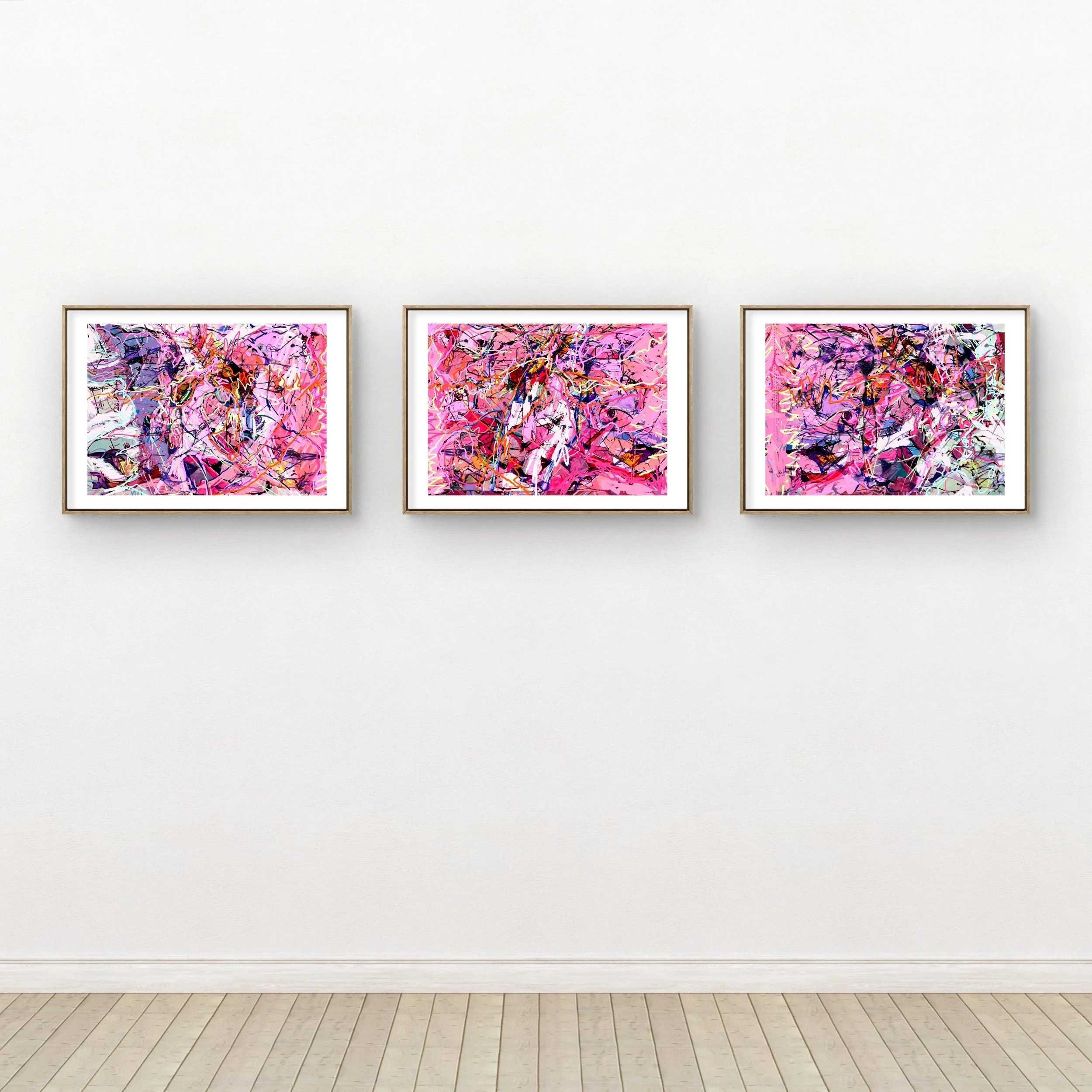 Three framed abstract paintings with pink backgrounds and multicolored splashes and lines, hung on a white gallery wall.