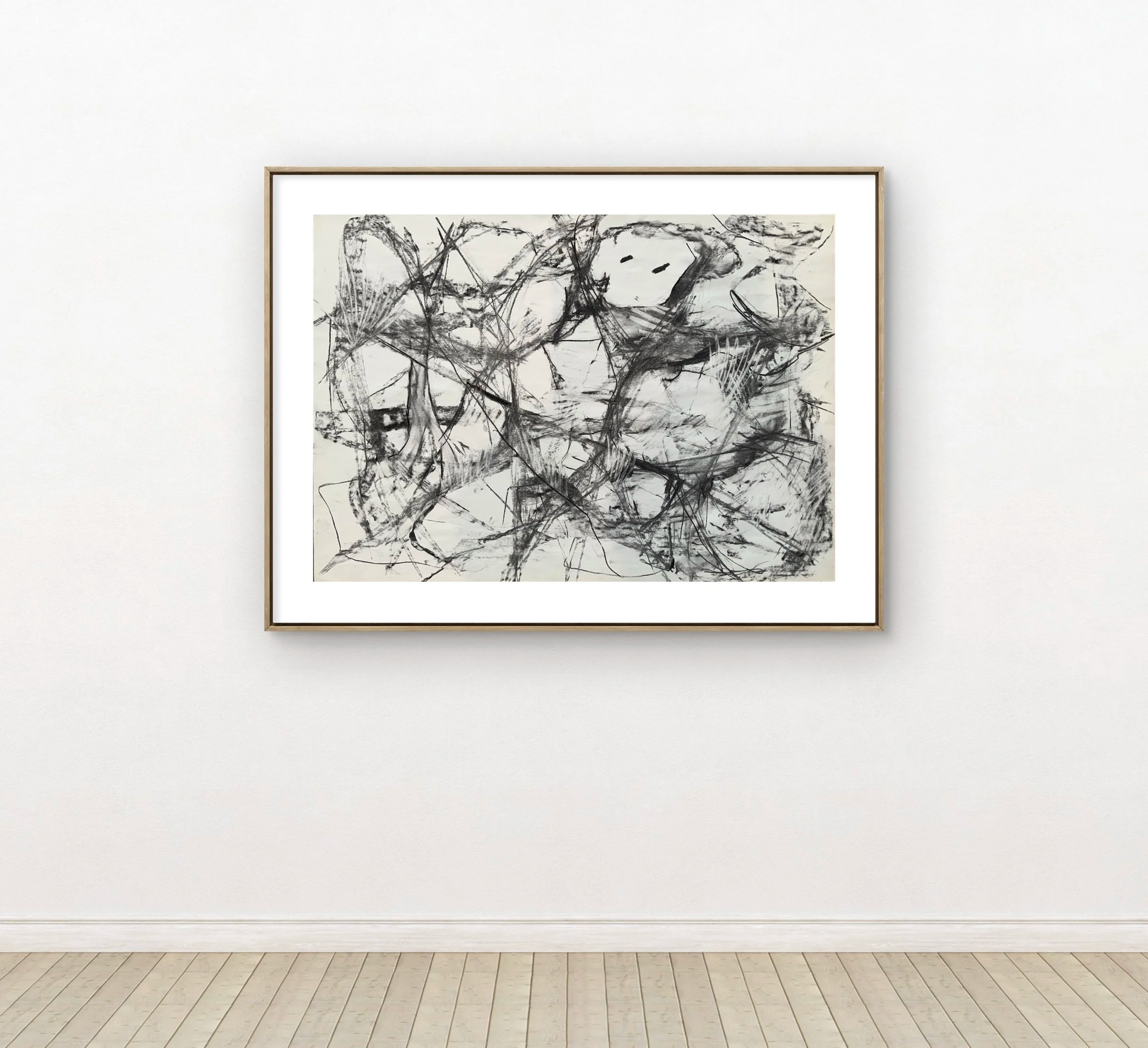 Abstract black and white drawing with bold lines and shapes on a white background, framed on a white gallery wall.