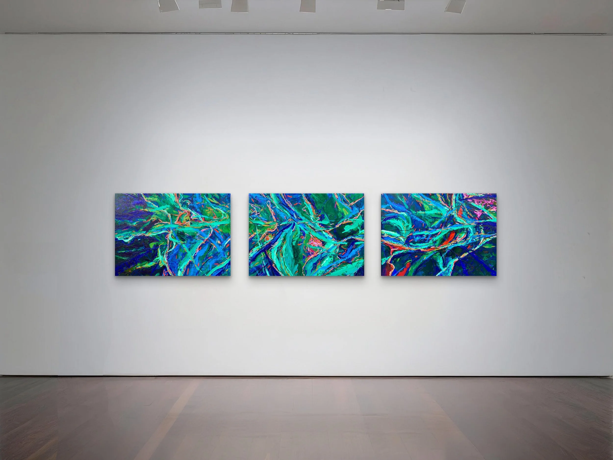 Three colorful abstract paintings with swirling, vibrant lines hang on a white gallery wall, illuminated by ceiling lights.