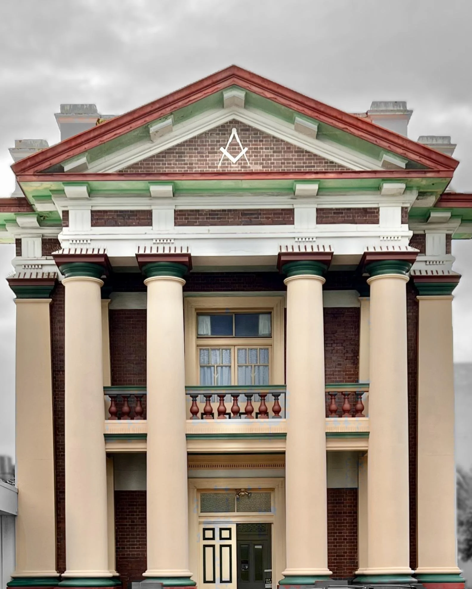 A large Masonic Hall in Mackay, Queensland with columns, a balcony, and decorative architectural elements