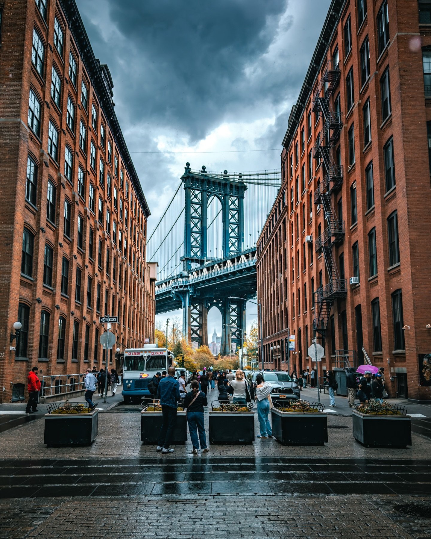In DUMBO, Brooklyn &mdash; everyone lining up for that classic Manhattan Bridge shot. My first time here though, under this gloomy afternoon sky.

Fun fact: DUMBO actually stands for &ldquo;Down Under the Manhattan Bridge Overpass.&rdquo; I didn&rsqu