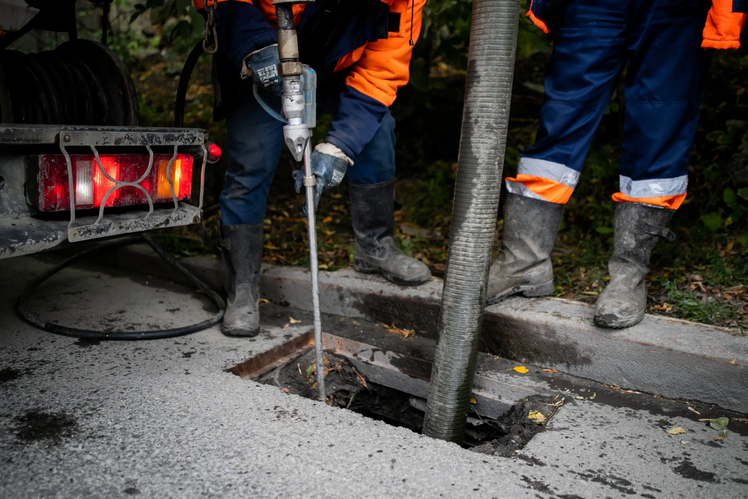 Cleaning storm drains from debris, clogged drainage systems are cleaned with a pump and water.