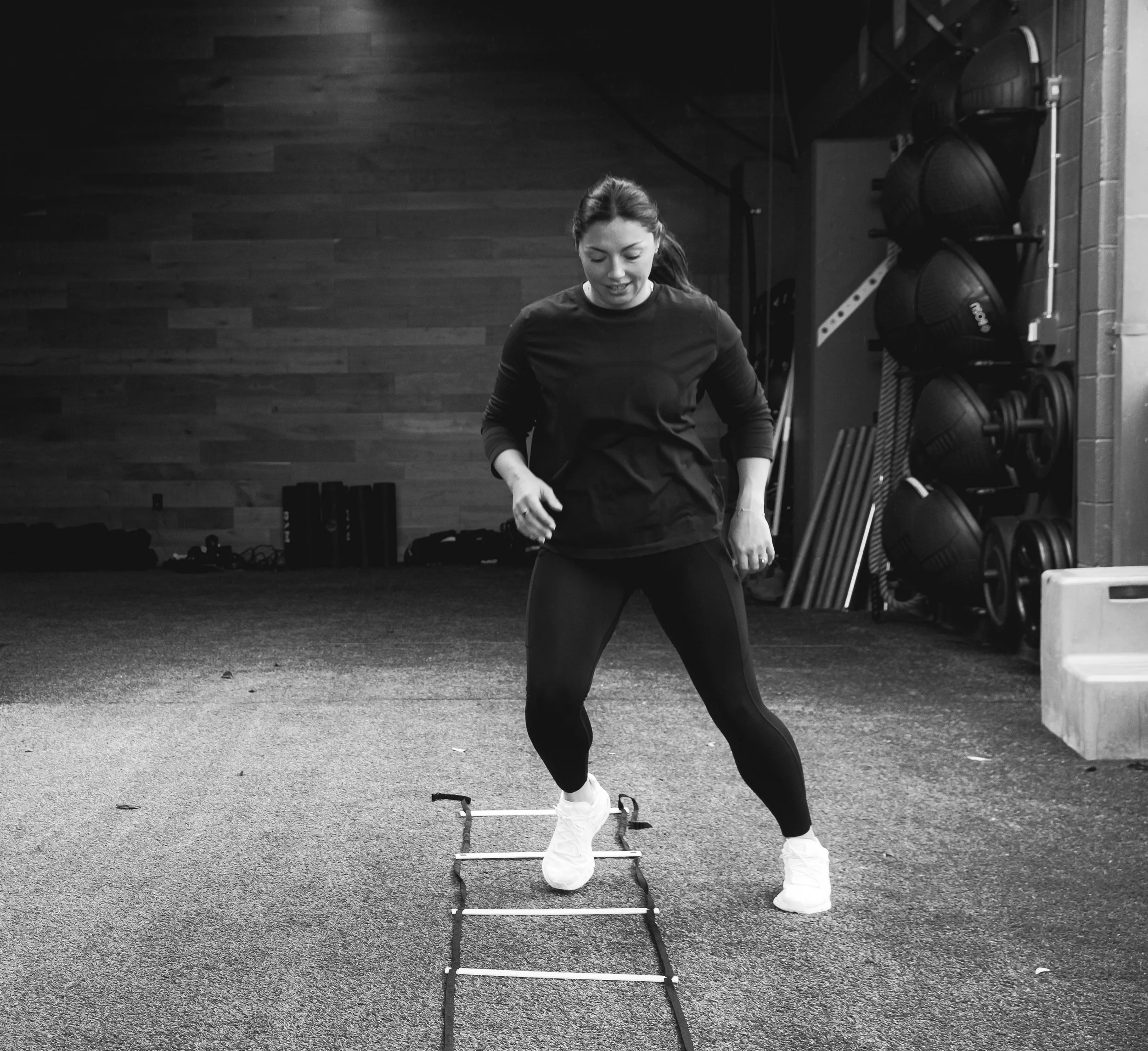 A female physical therapist coaching a patient through exercise and discussing strategies for decreasing pain 