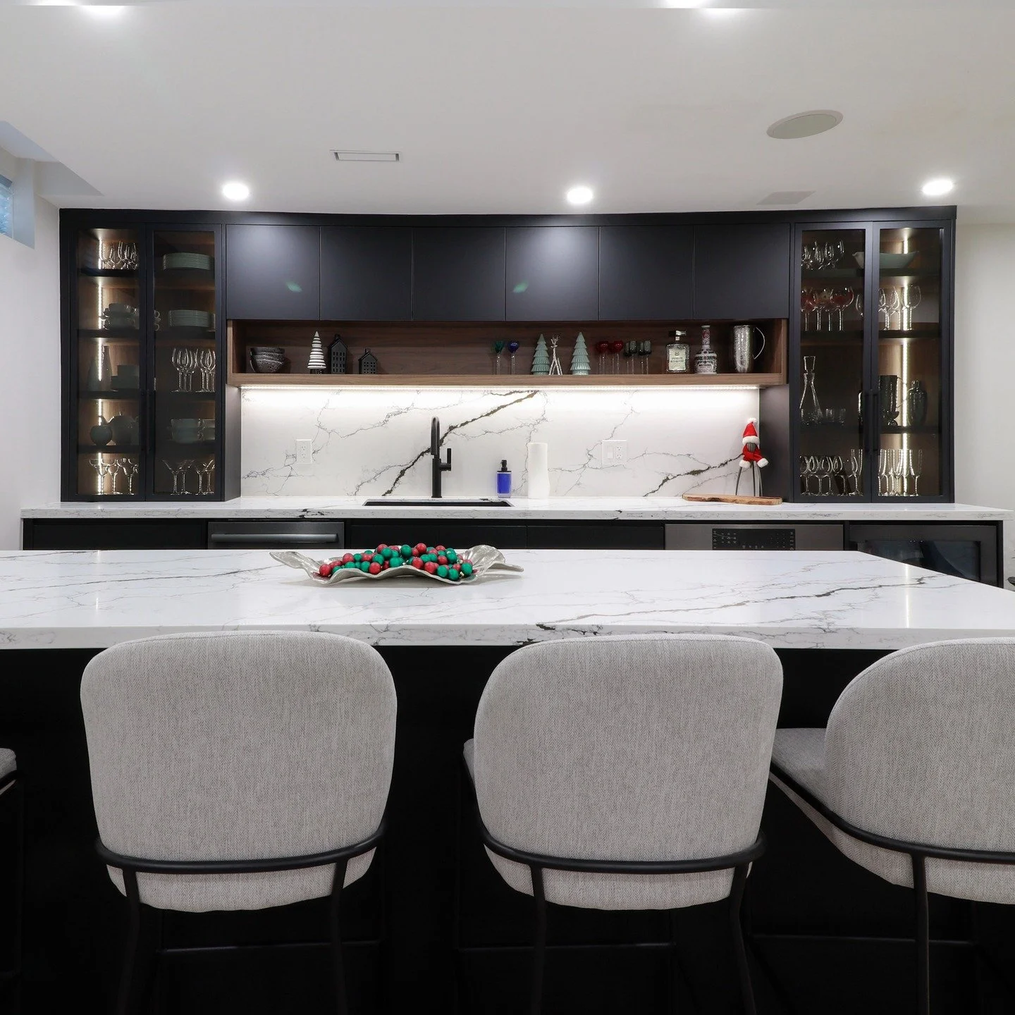 A custom bar designed with intention and restraint.

Matte black cabinetry, warm wood interiors, integrated lighting, and a waterfall island come together to create a space that feels grounded, functional, and refined.

Design that elevates every lev