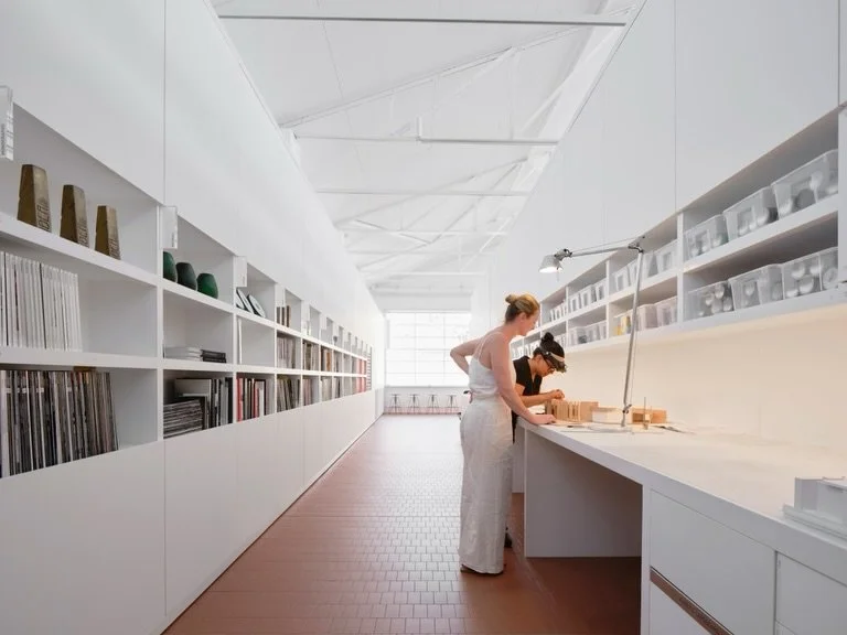 Smart Design Studio&rsquo;s workplace is a modernist, clean, white canvas where creativity flourishes. 

The space boasts an impressively crafted, curved brick facade, a sophisticated temperature regulating system to compensate for the dramatic glass