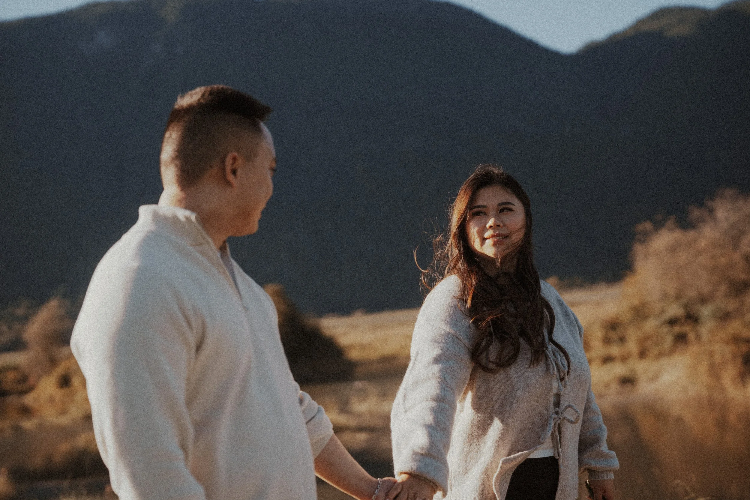  The couple shares a loving glance, hand-in-hand, against the beautiful Pitt Lake backdrop. 