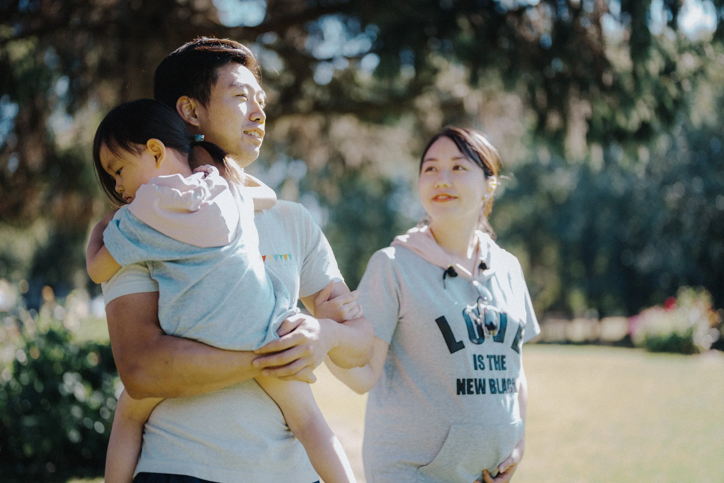 Family moment at Richmond Country Farms with child resting on shoulder