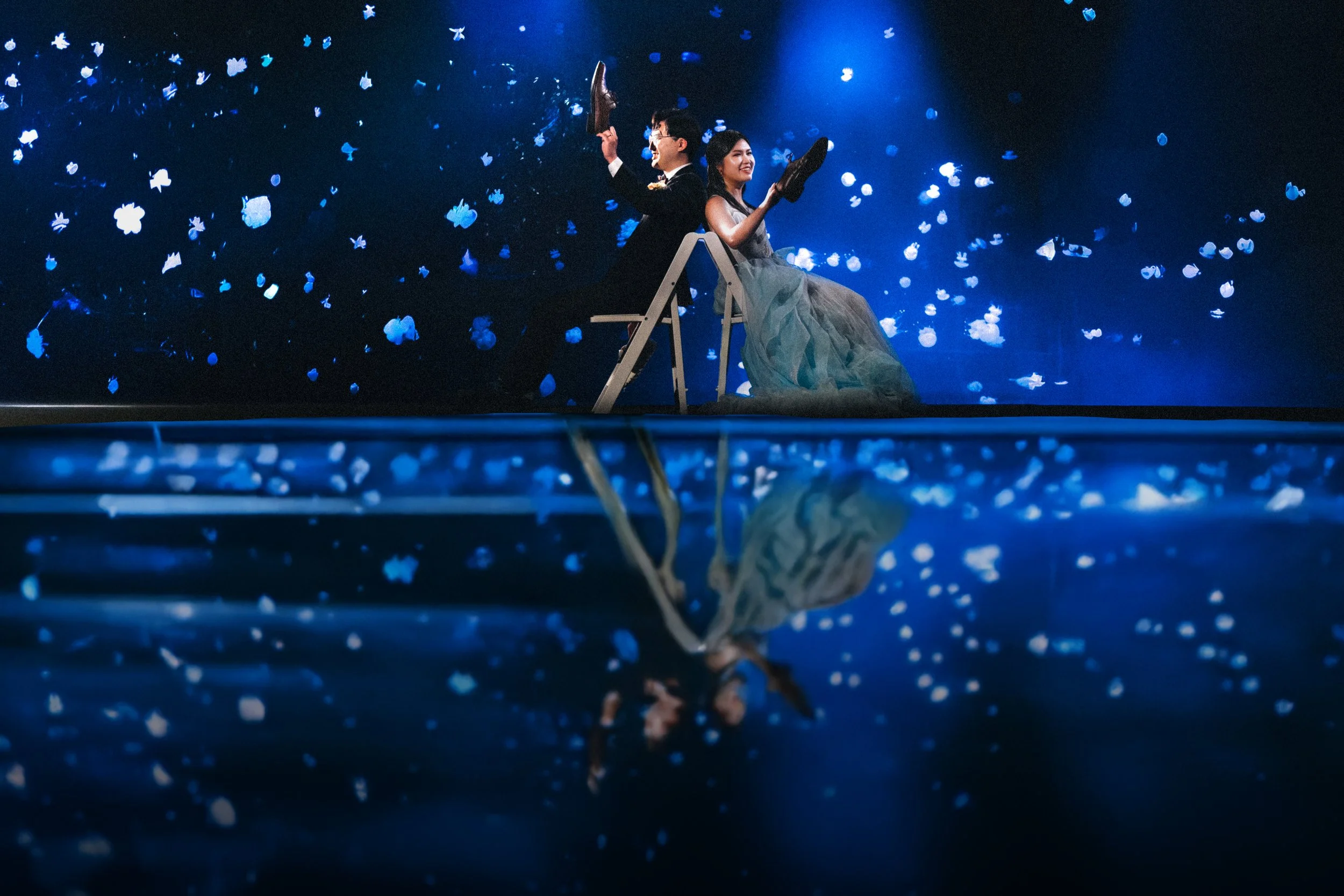  A fun moment during the  Vancouver Aquarium reception  as the couple plays the shoe game under dramatic blue lights. 