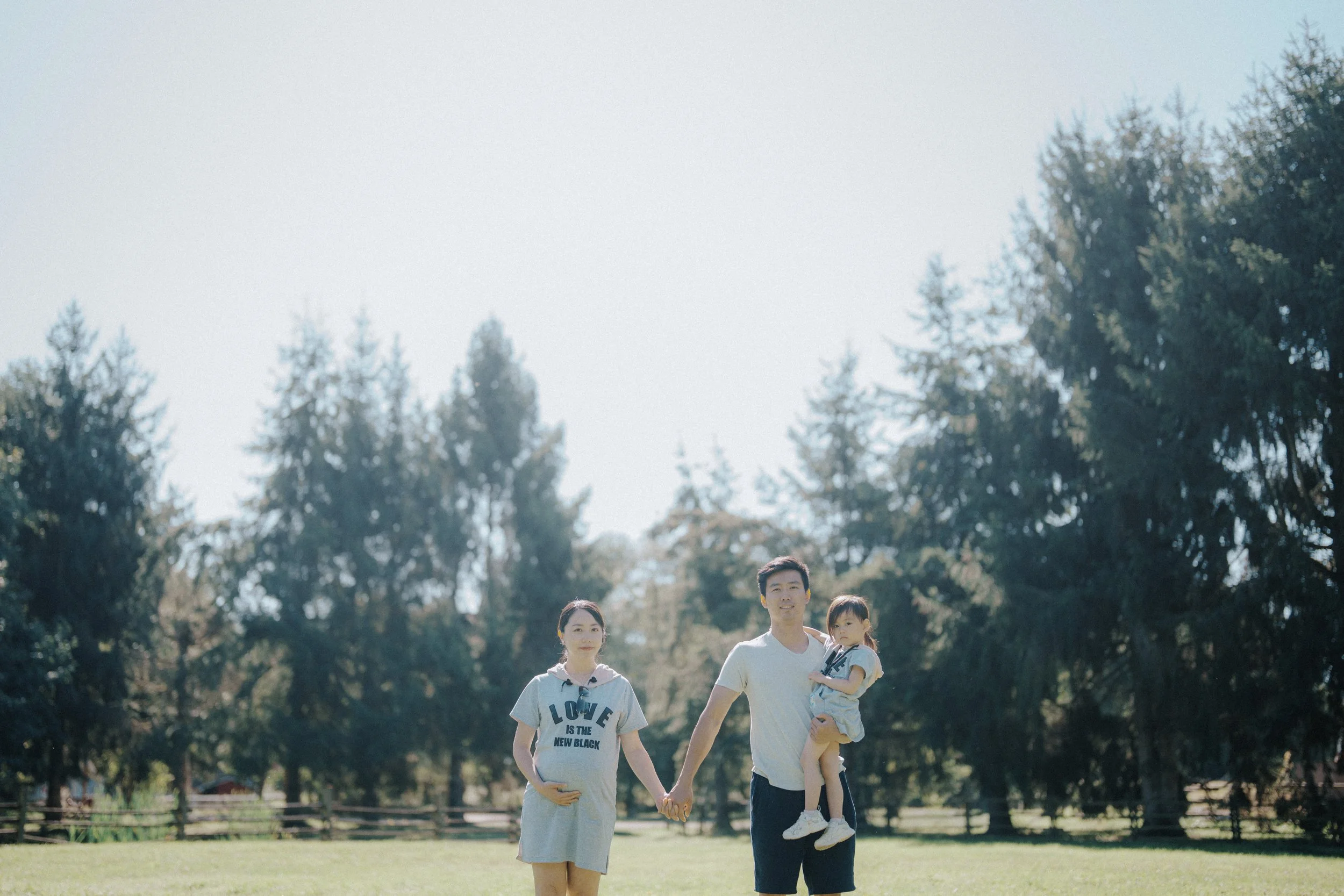 Family walking across a sunlit lawn at Richmond Country Farms.