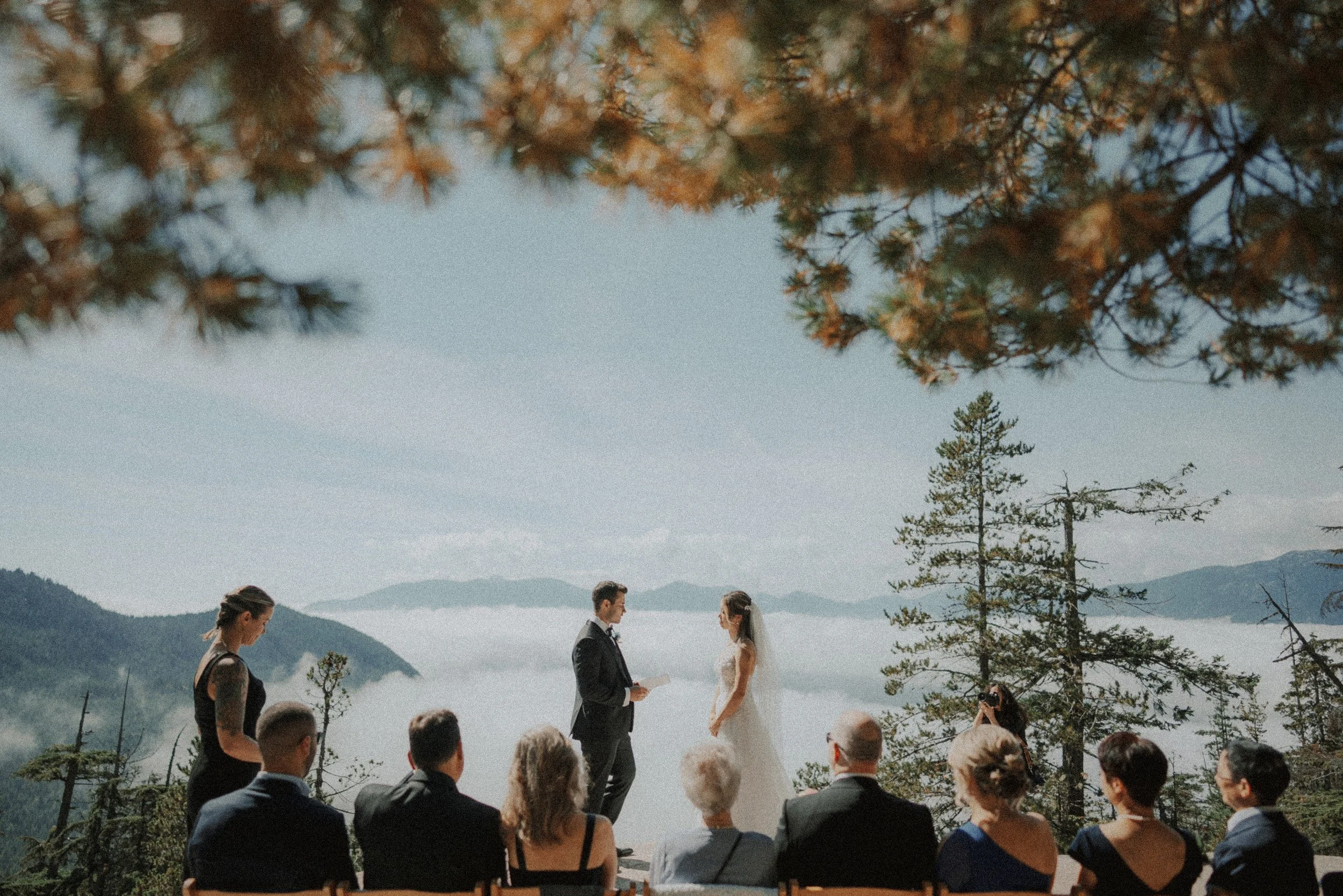 Guests watching the couple during their outdoor mountain ceremony.