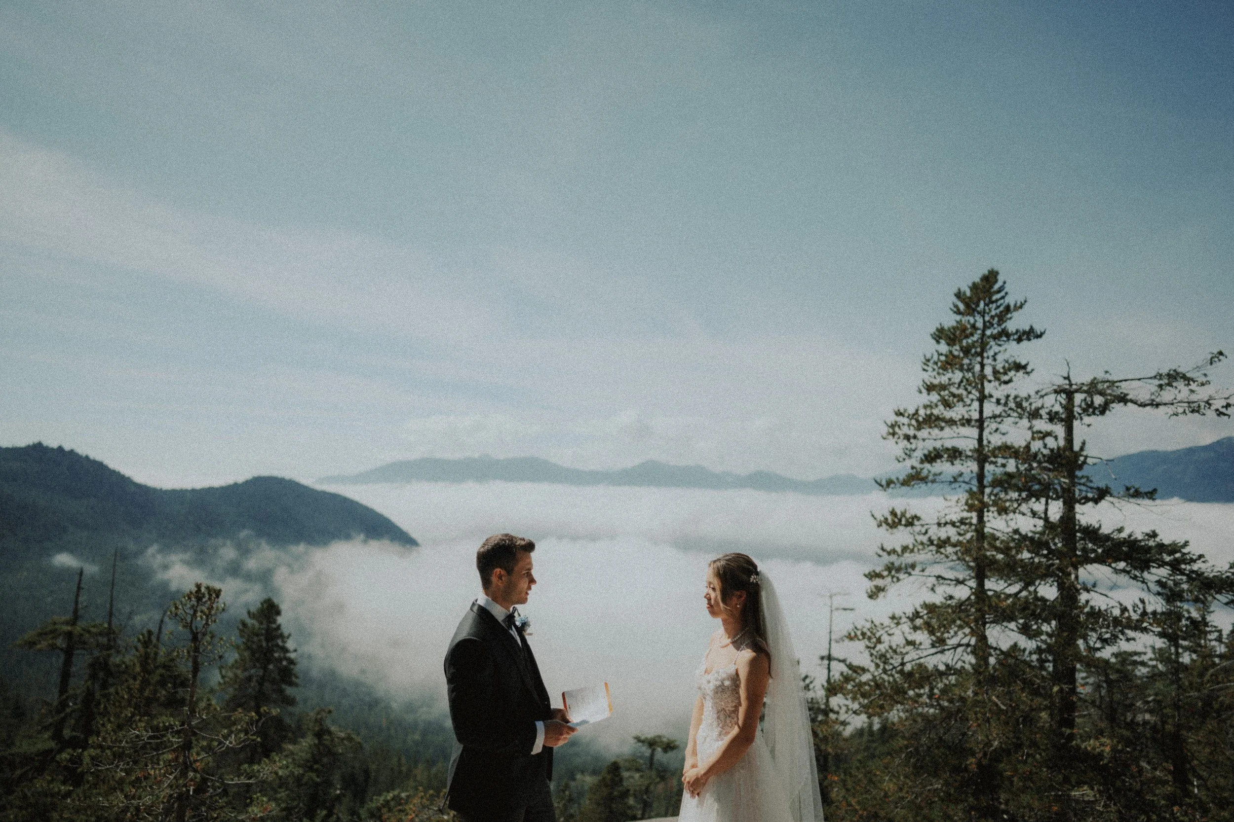 Groom facing the bride while speaking his wedding vows.
