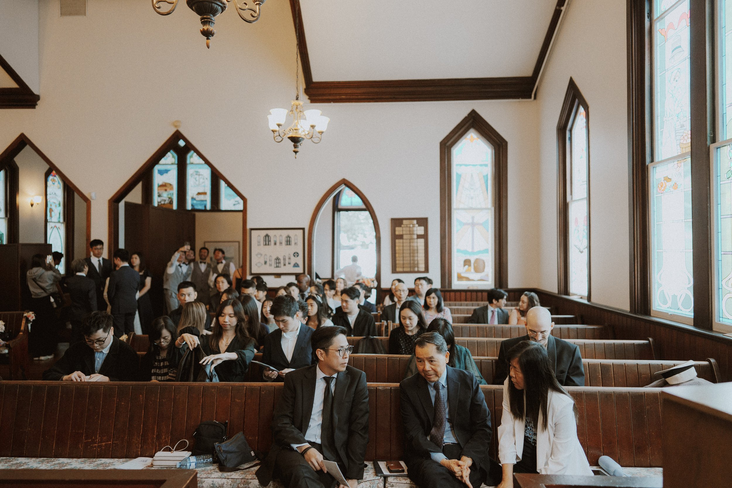 Guests waiting in Minoru Chapel's timber-trimmed ceremony room.