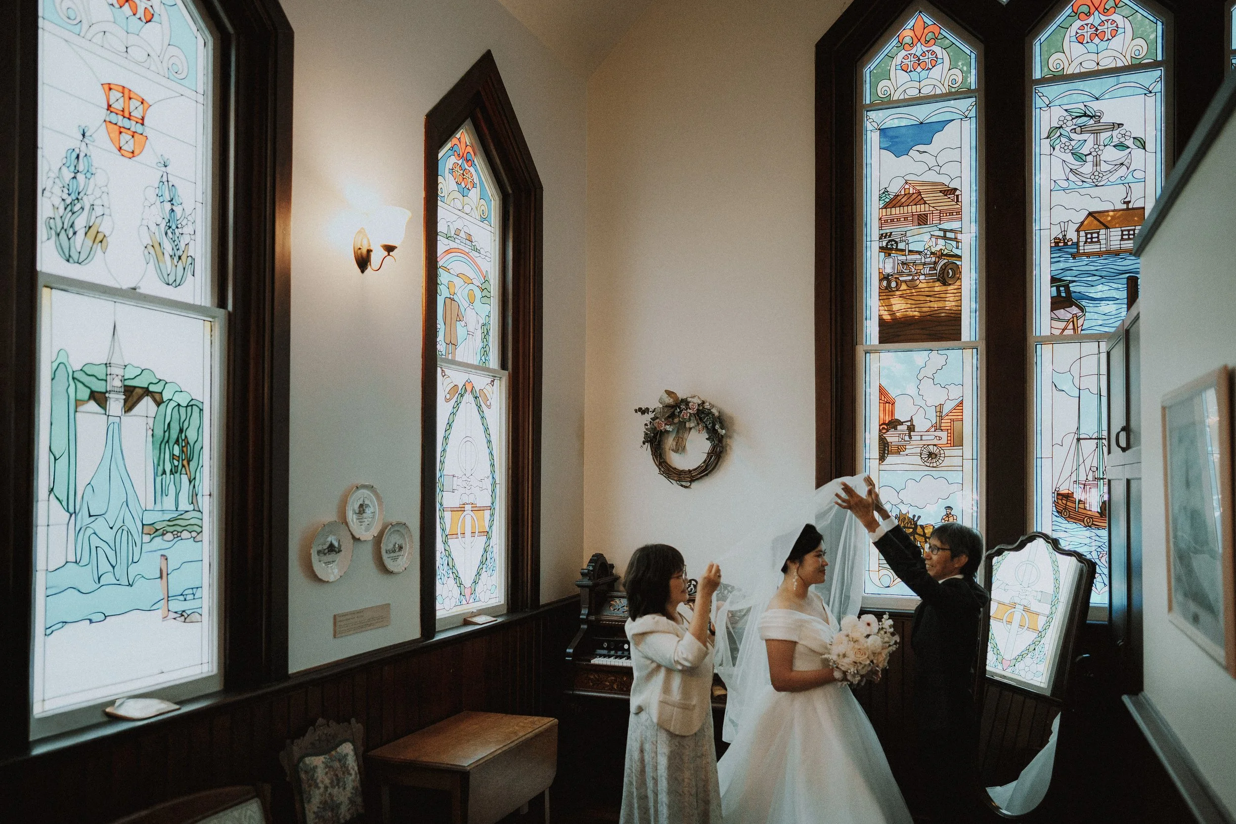 Bride's veil being lifted over her head inside Minoru Chapel.