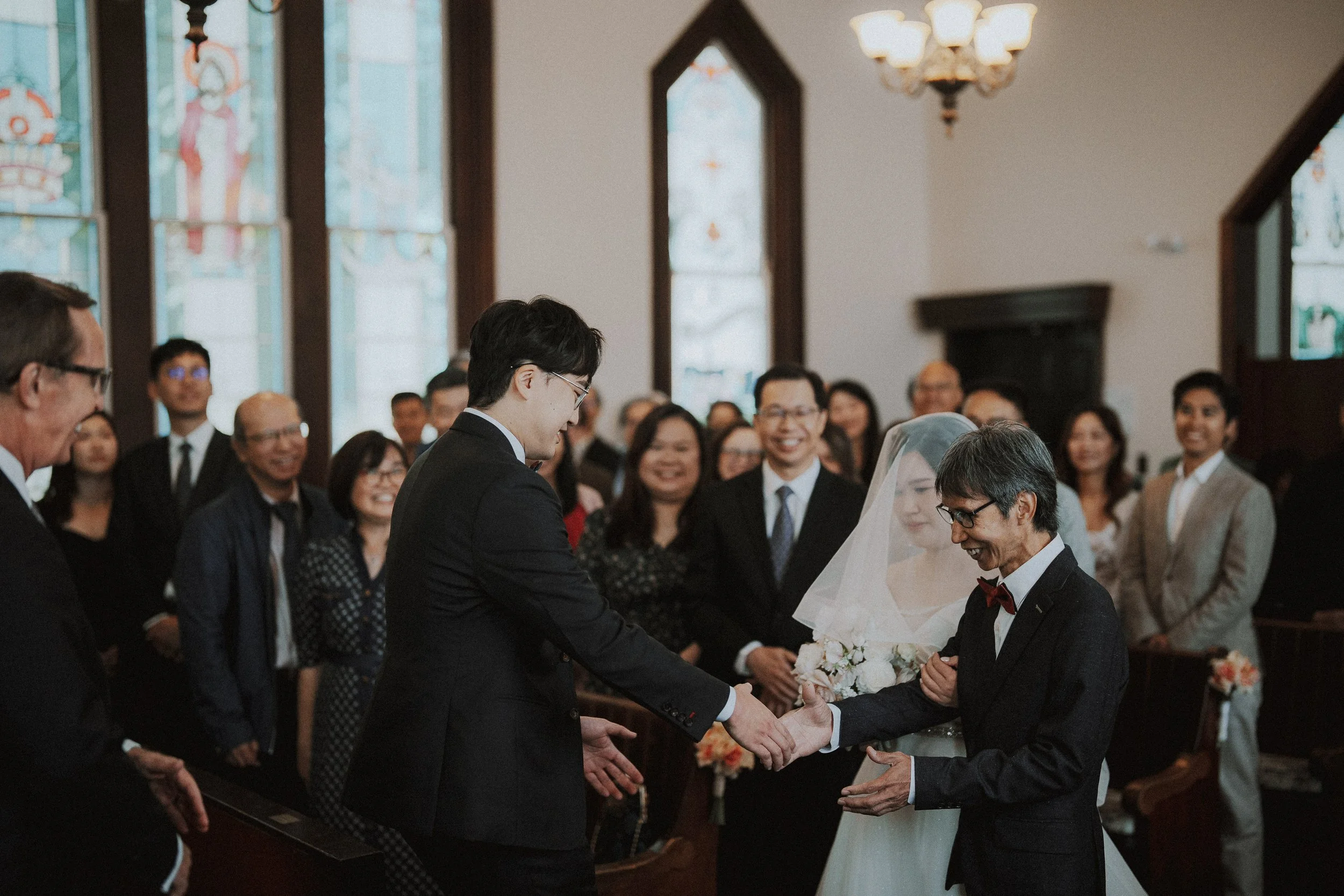 Bride greeting the groom at the front of Minoru Chapel.