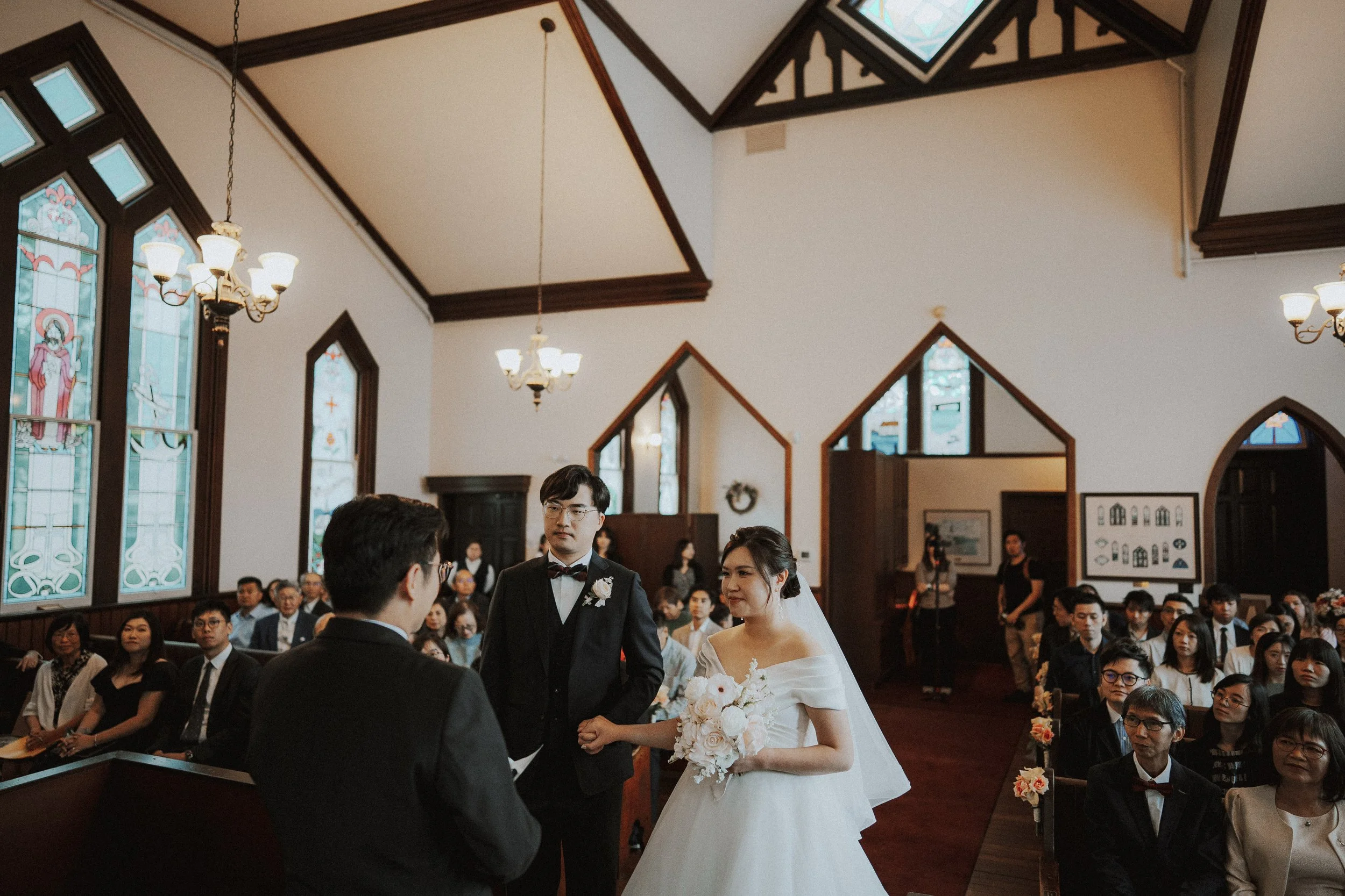 Bride and groom standing together during their Minoru Chapel wedding ceremony.