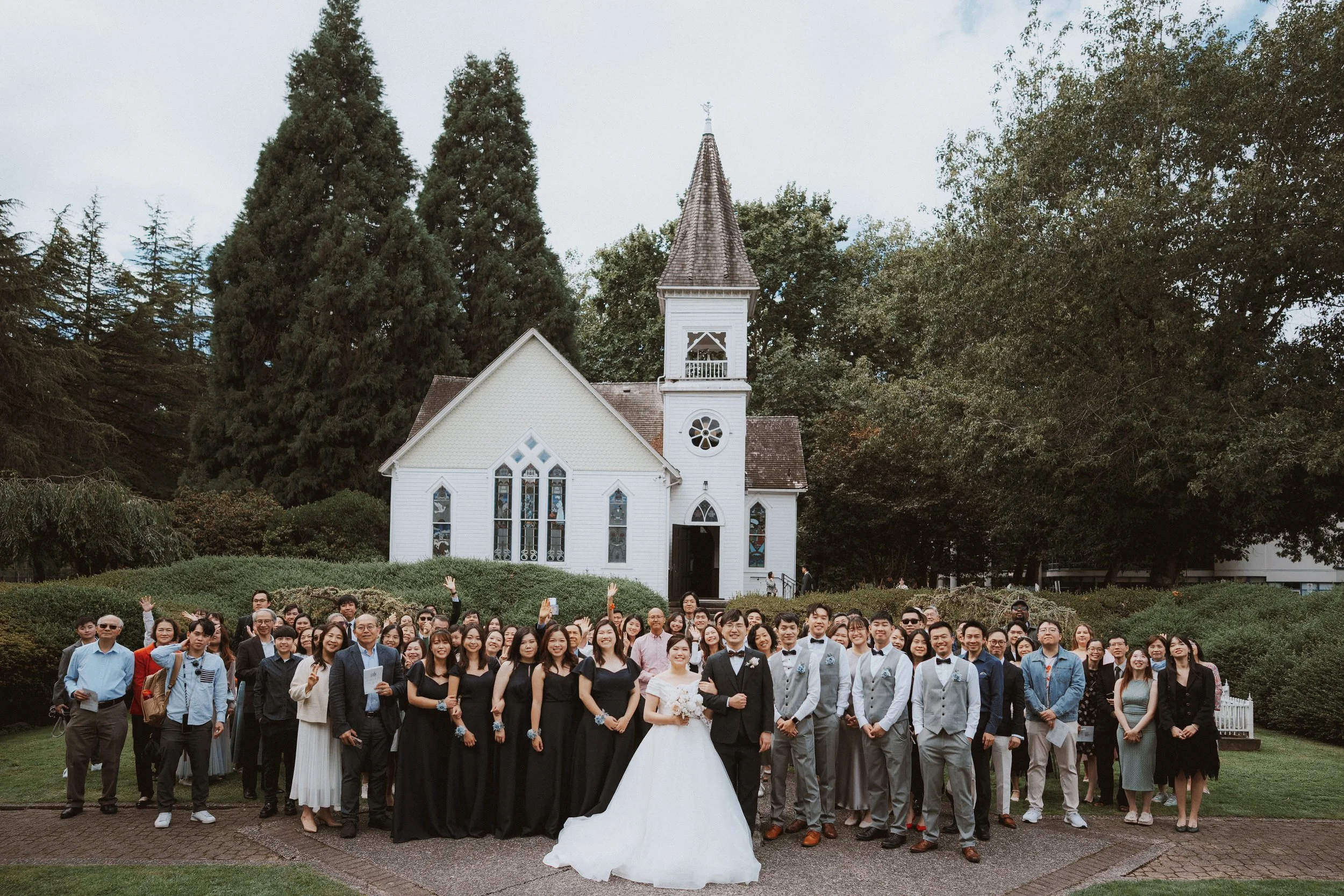 Large wedding group portrait on the lawn in front of Minoru Chapel.