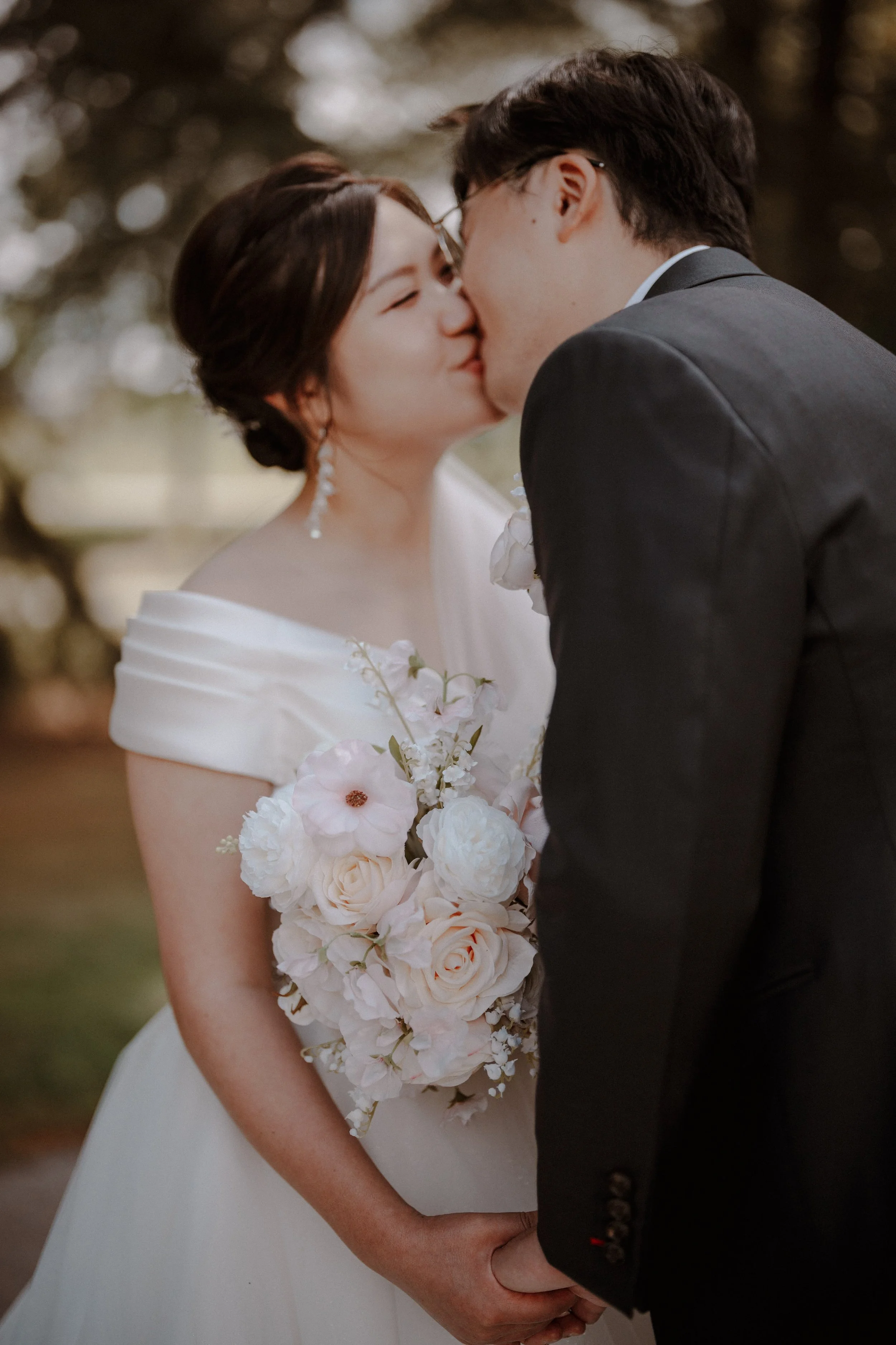 Close-up of the bride and groom kissing in the chapel gardens.