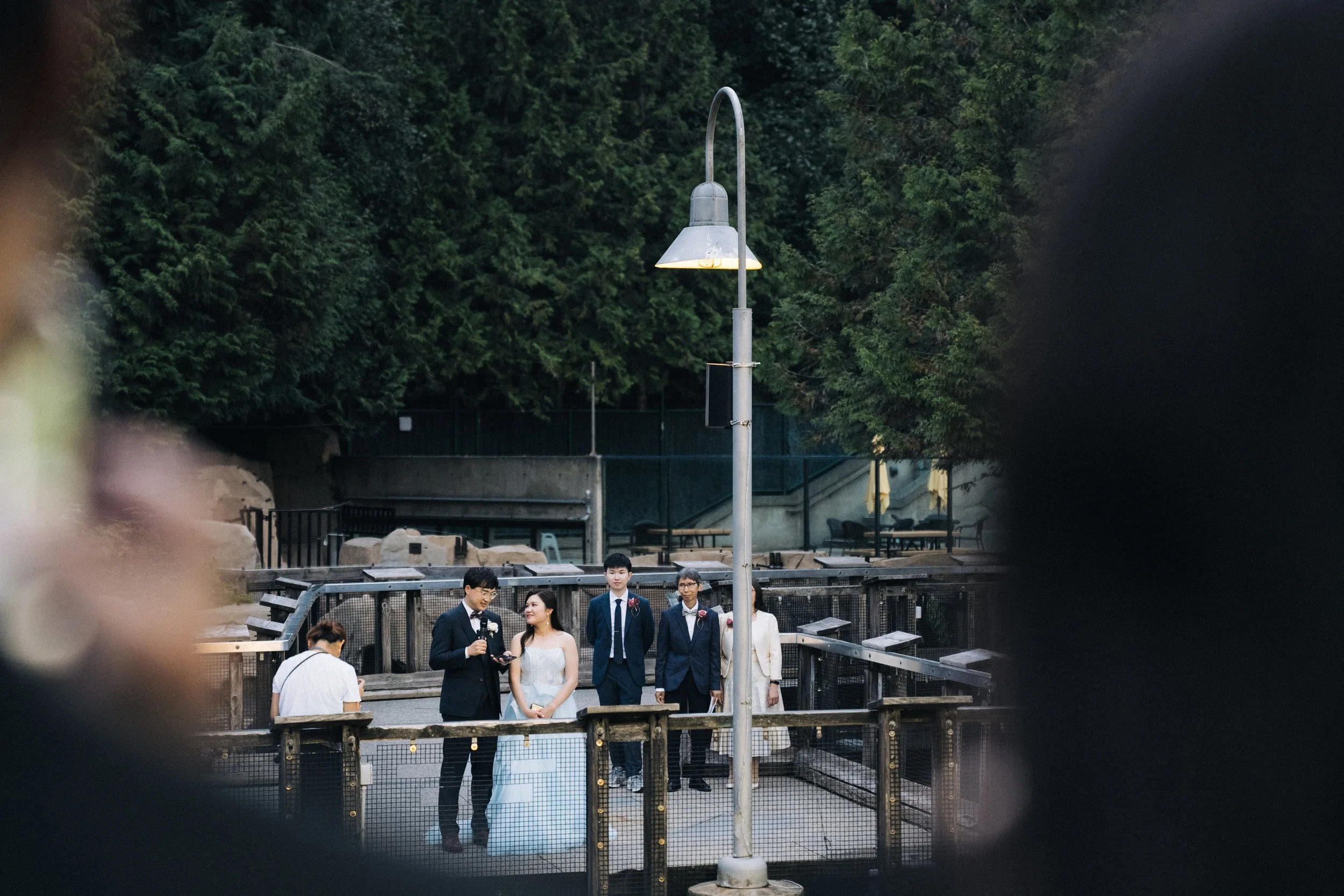 Wide view of the couple and guests around an outdoor Vancouver Aquarium exhibit.