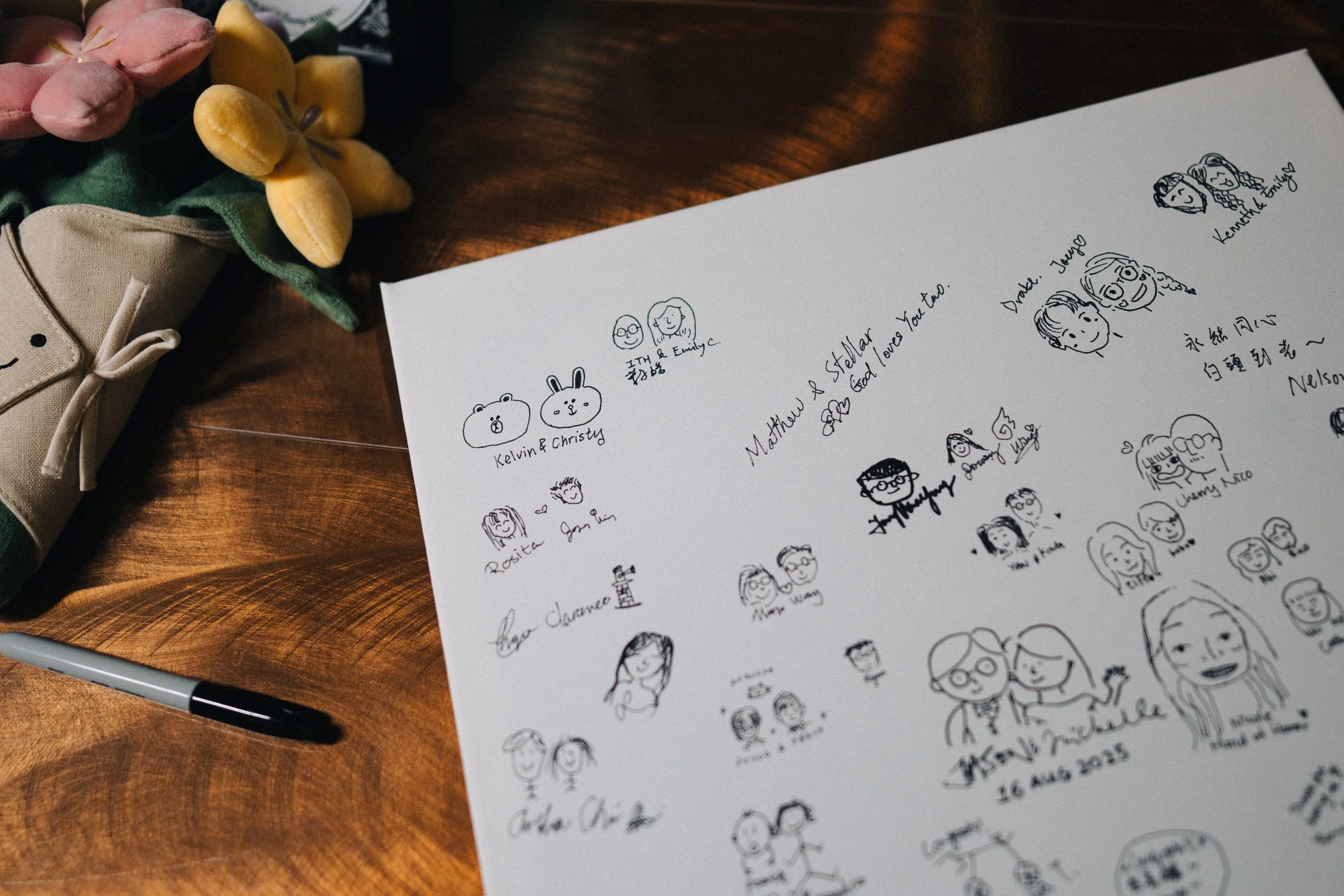 Illustrated wedding guestbook with small portrait drawings and handwritten messages.