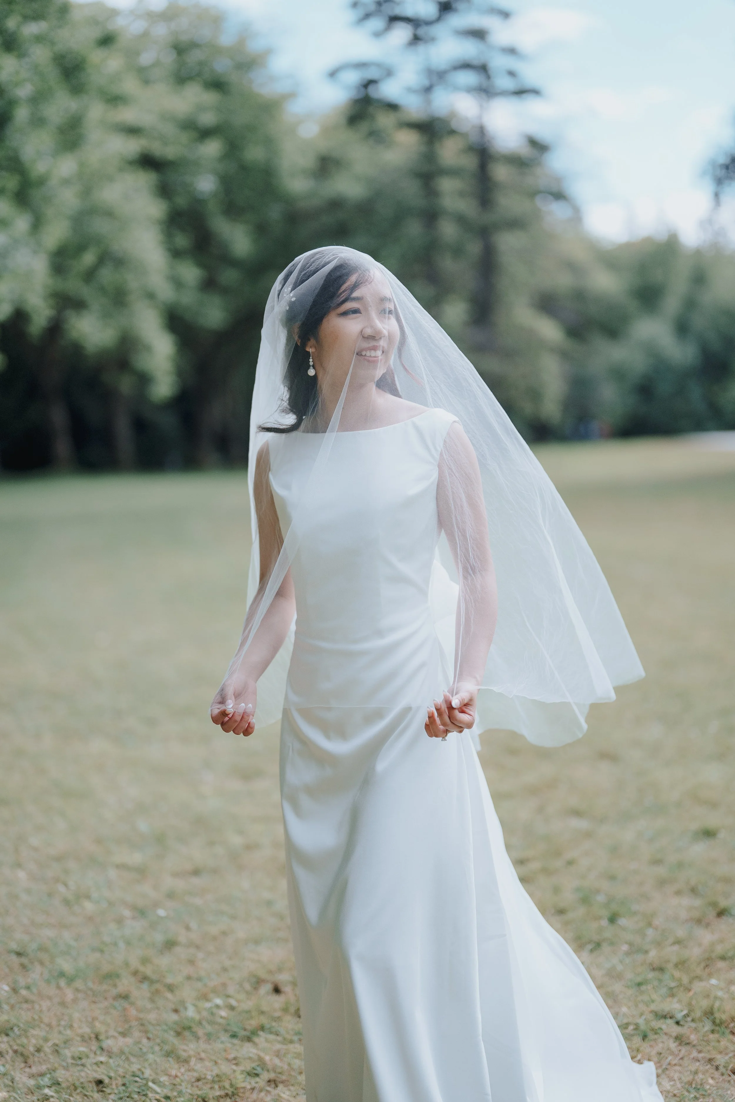 Chloe smiling beneath her veil in Stanley Park