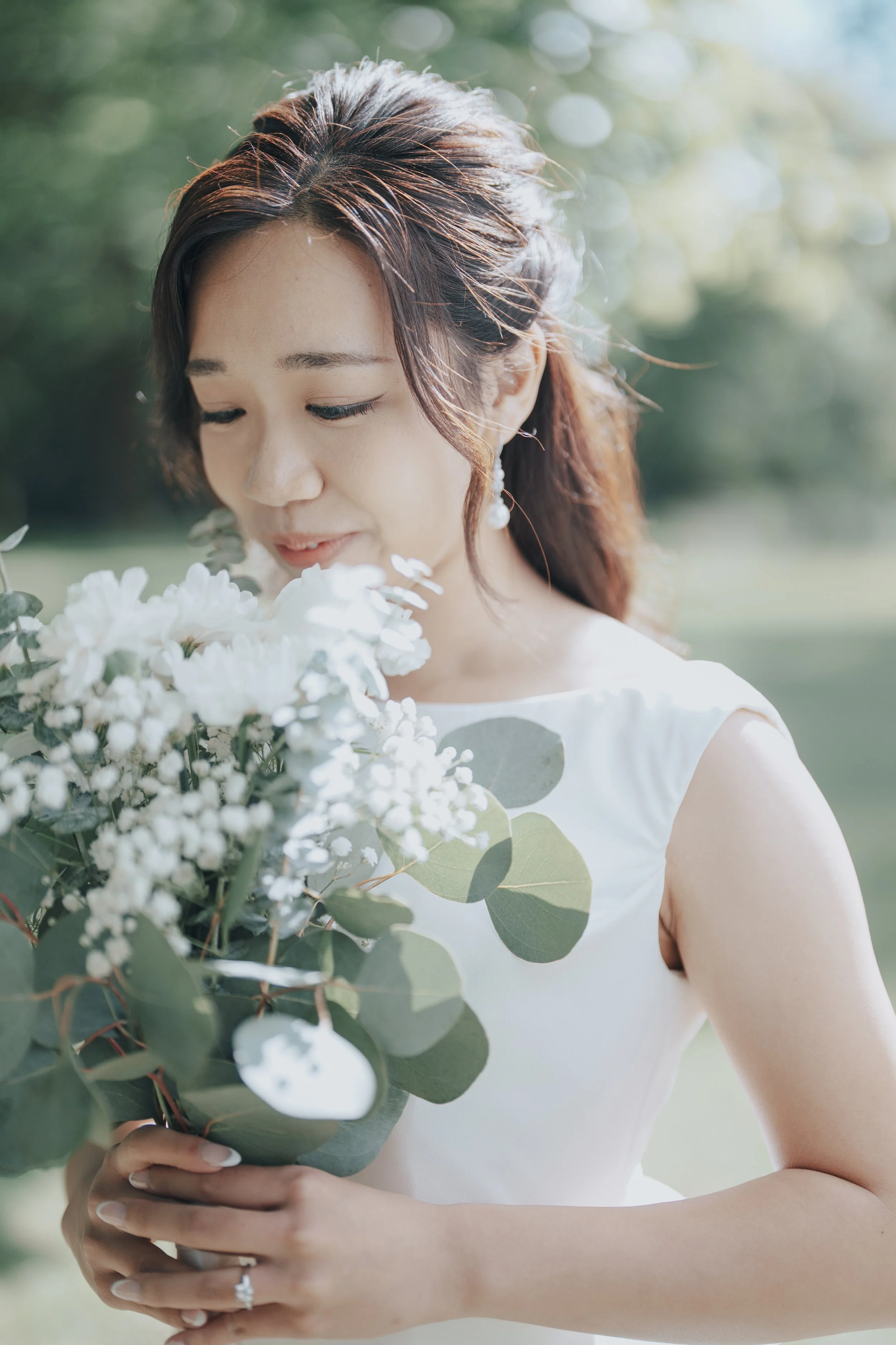 Chloe holding her bouquet in soft Stanley Park light, Vancouver