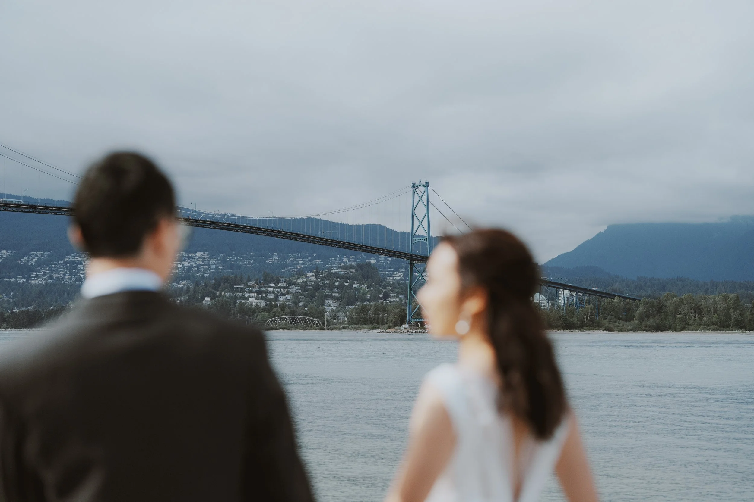 Chloe and Marco looking out across the water at Stanley Park