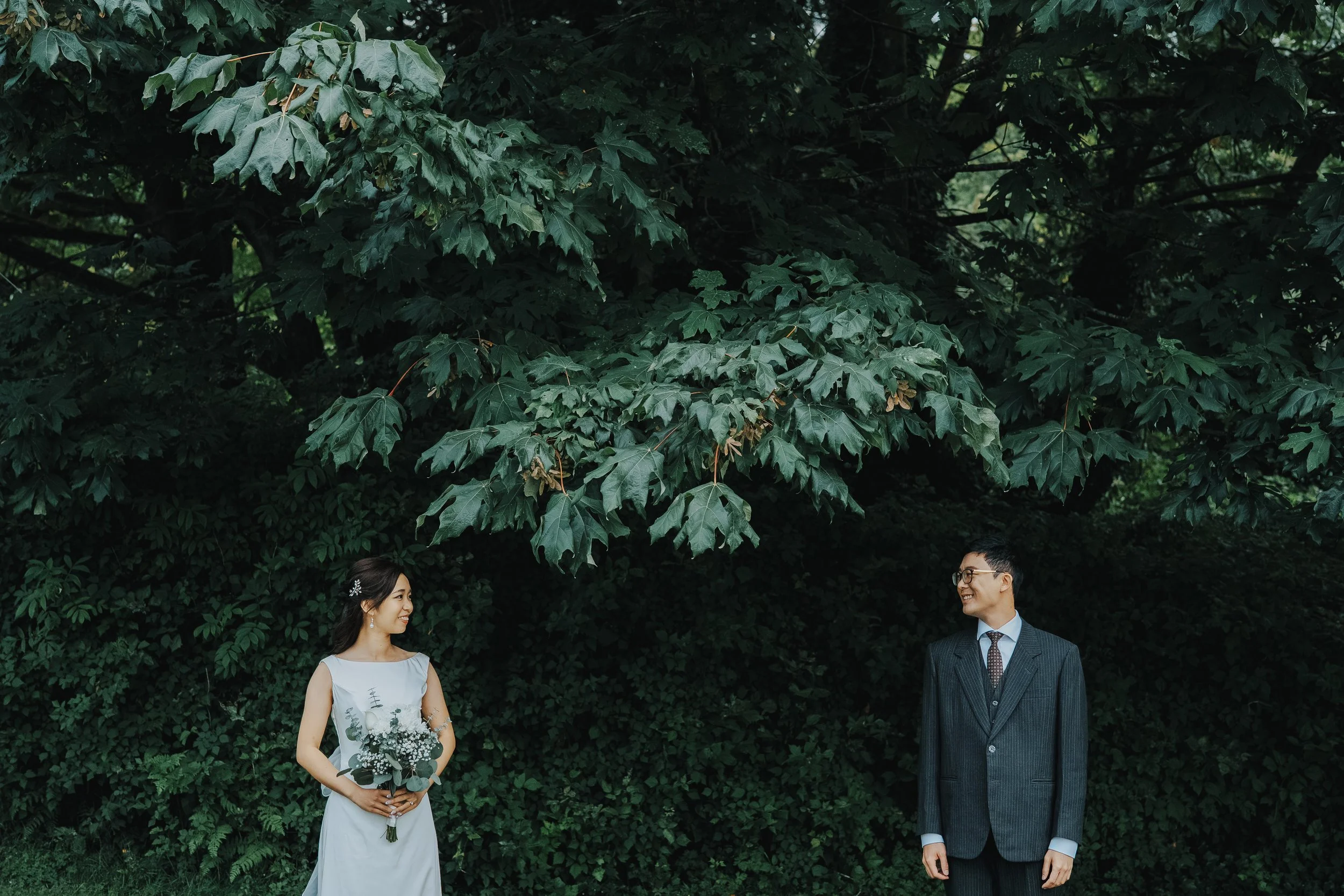 Chloe and Marco beneath the forest trees in Stanley Park