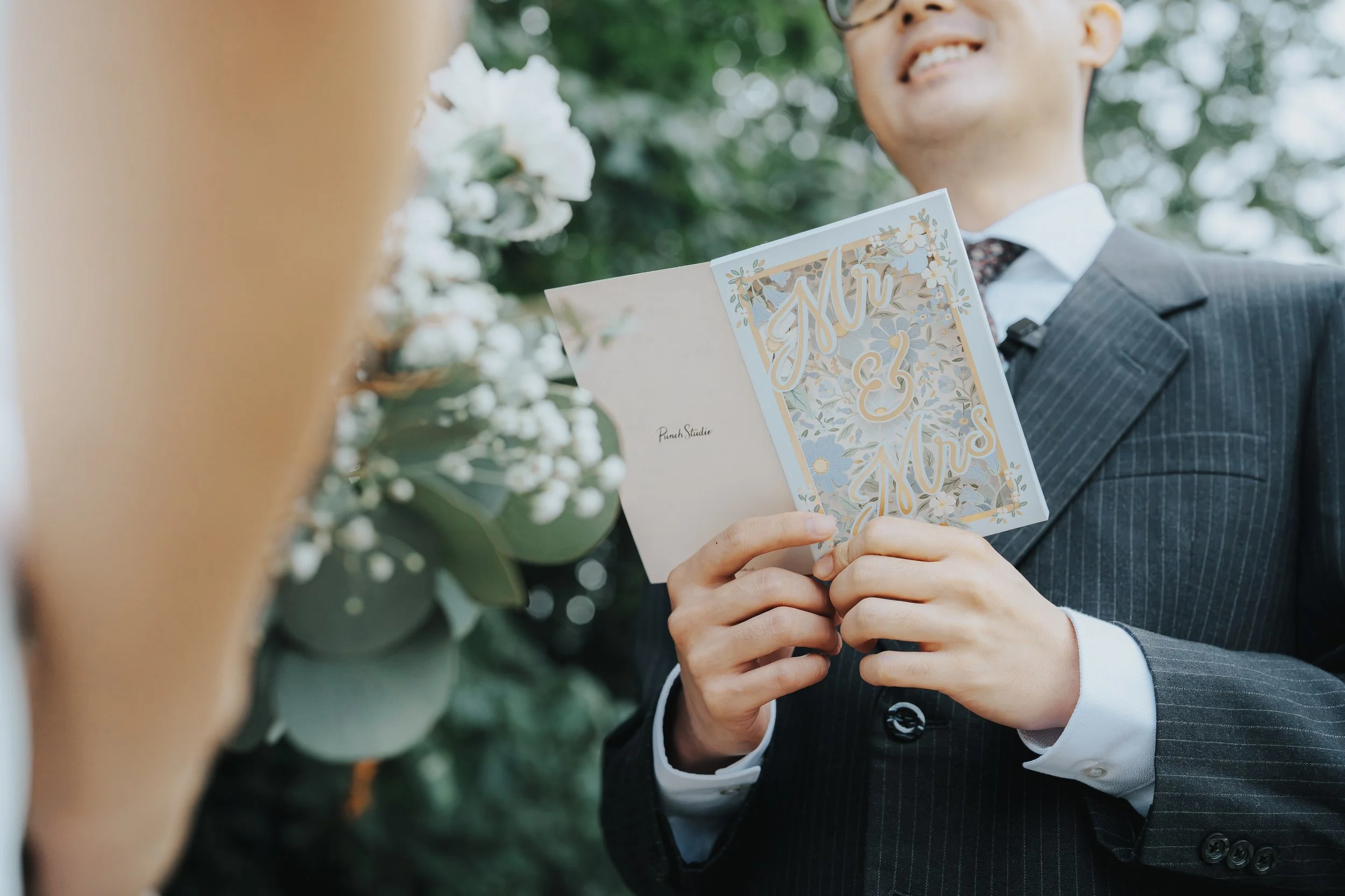 Marco holding a personal keepsake card at Stanley Park, Vancouver