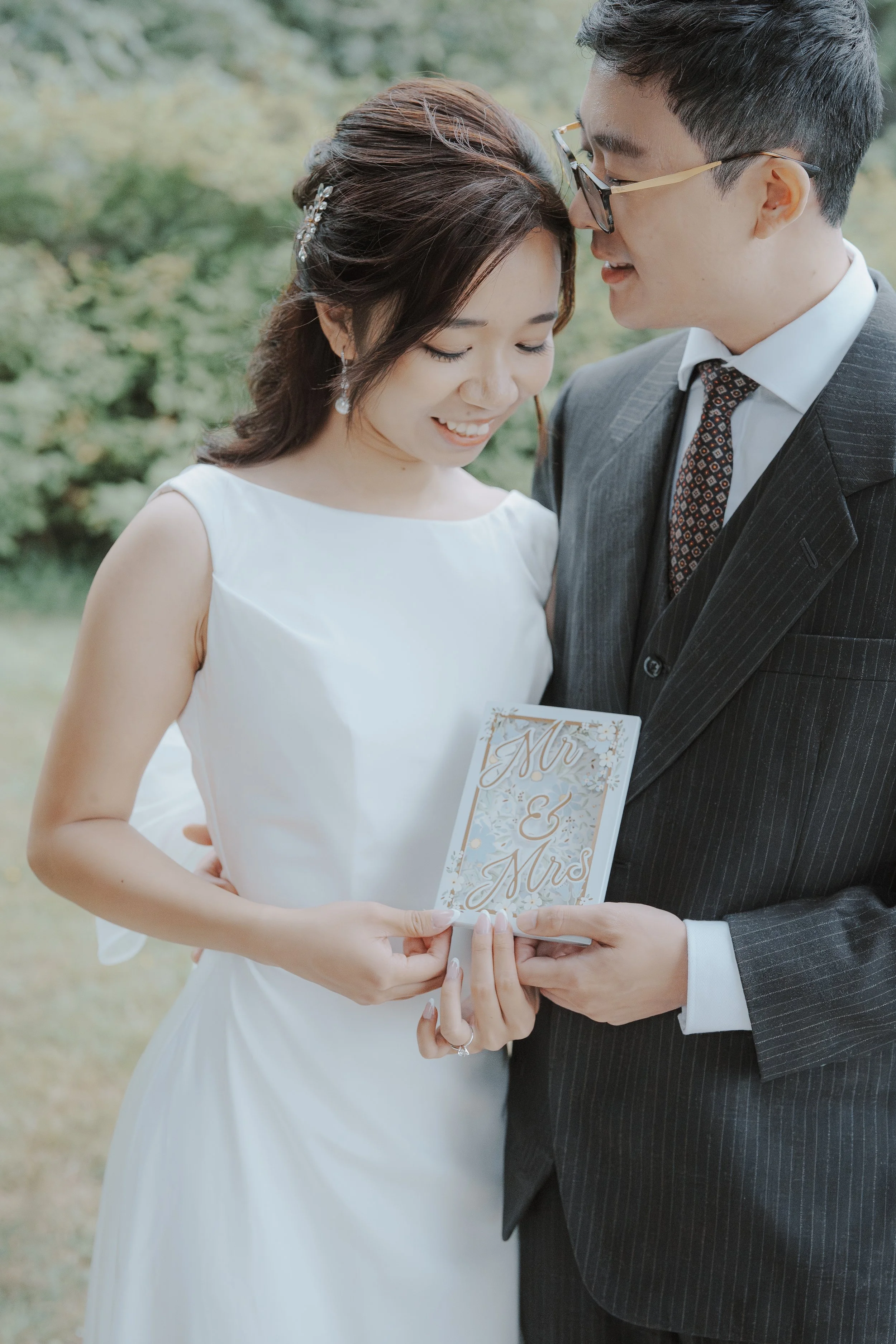 Chloe and Marco sharing a quiet moment with their card at Stanley Park