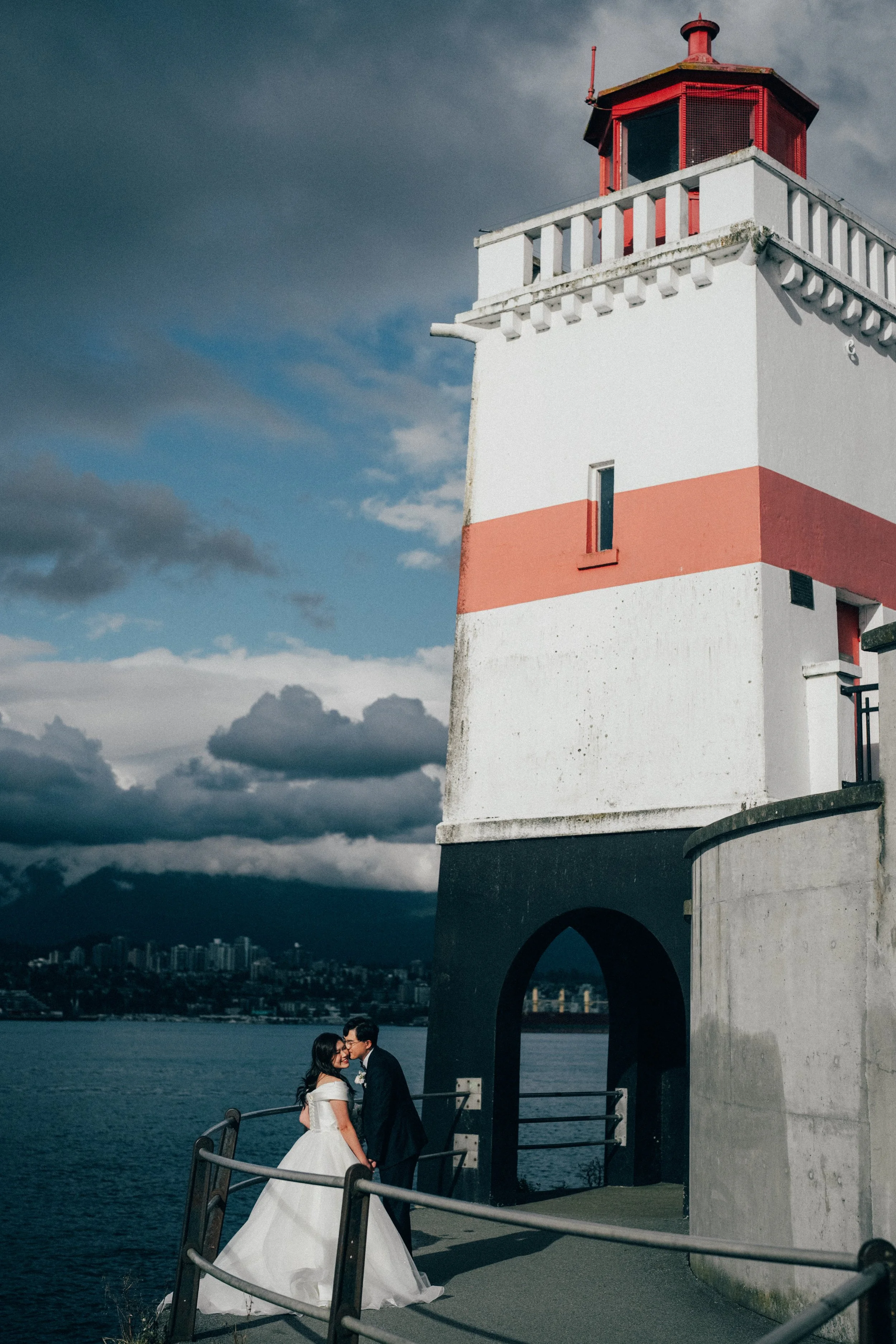  An intimate kiss between the couple next to the iconic  Stanley Park Lighthouse  and the ocean. 