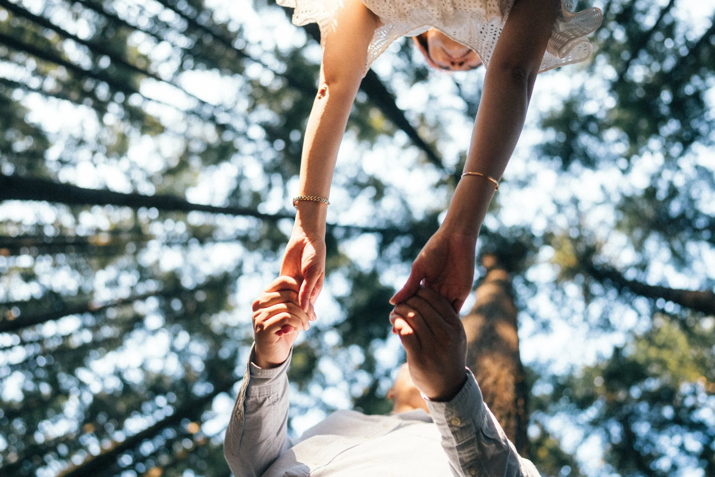  A unique low angle shot showing the beautiful connection between the couple and the towering trees above. 