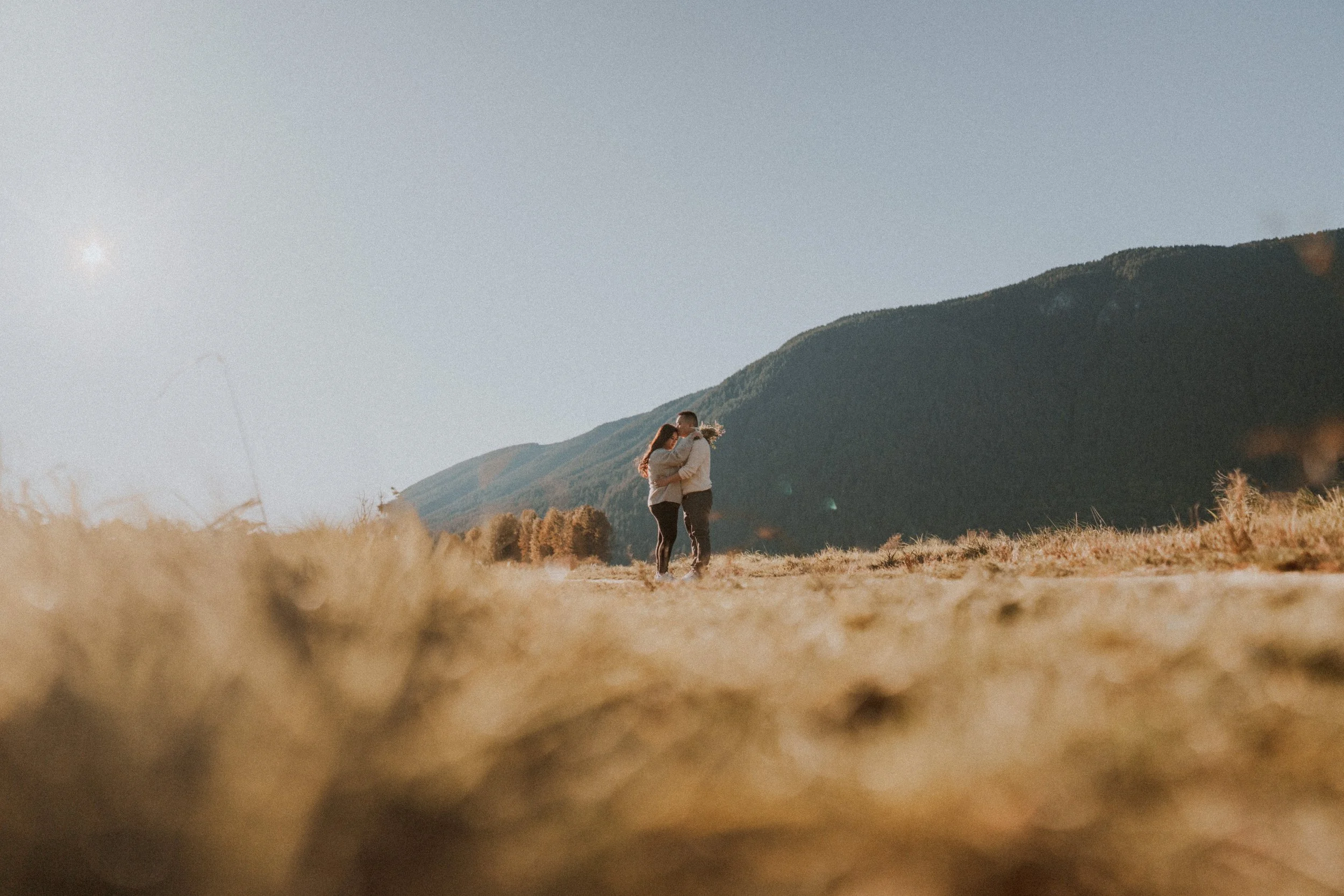  An intimate portrait of the couple looking into each other's eyes against the deep shadows of the mountain. 