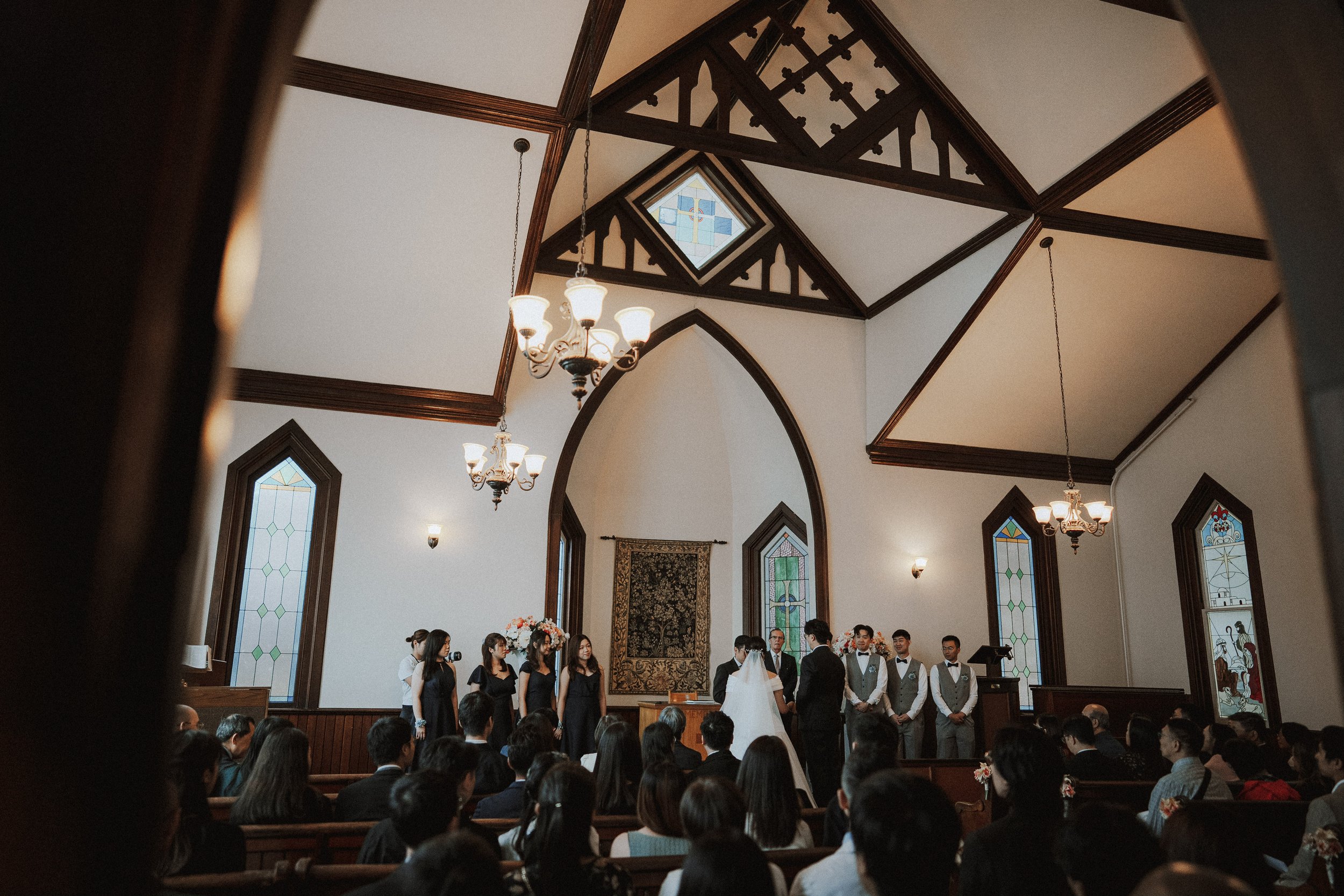  A beautiful interior shot of the historic  Minoru Chapel  during the vows, highlighting the wooden beams and unique structure. 