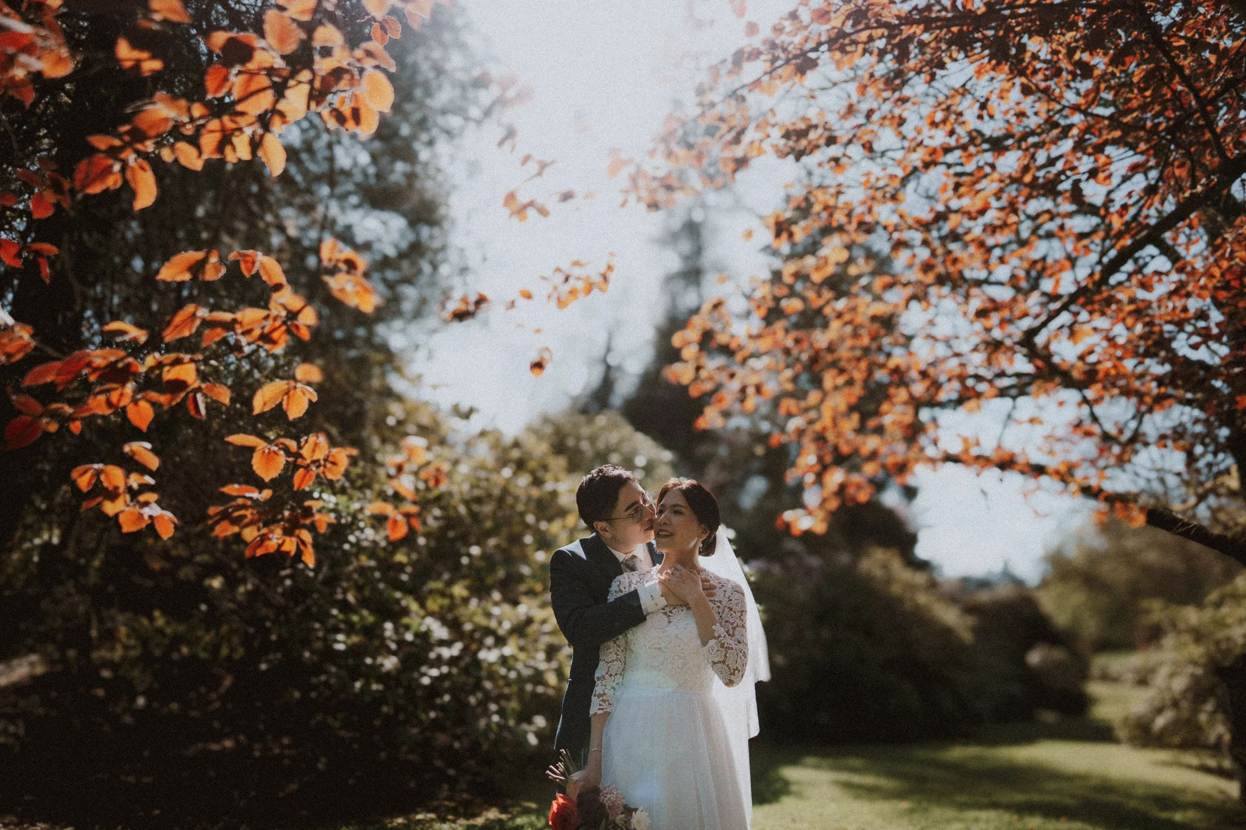  A tender hug shared by the couple, captured in the beautiful  warm light  of the garden. 